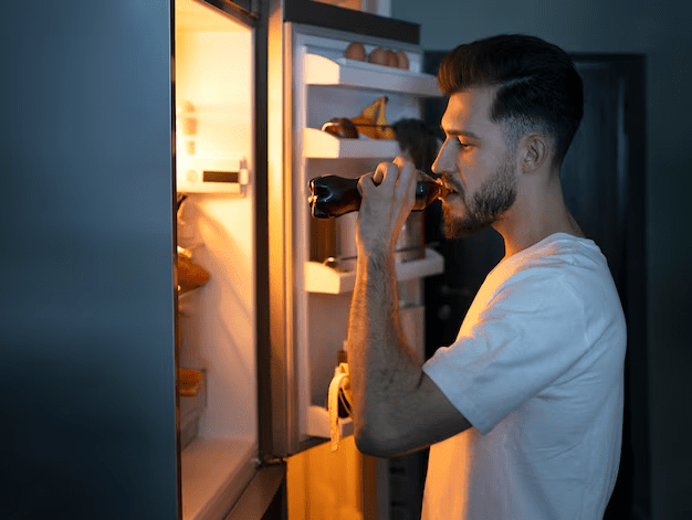 Man looking in refrigerator