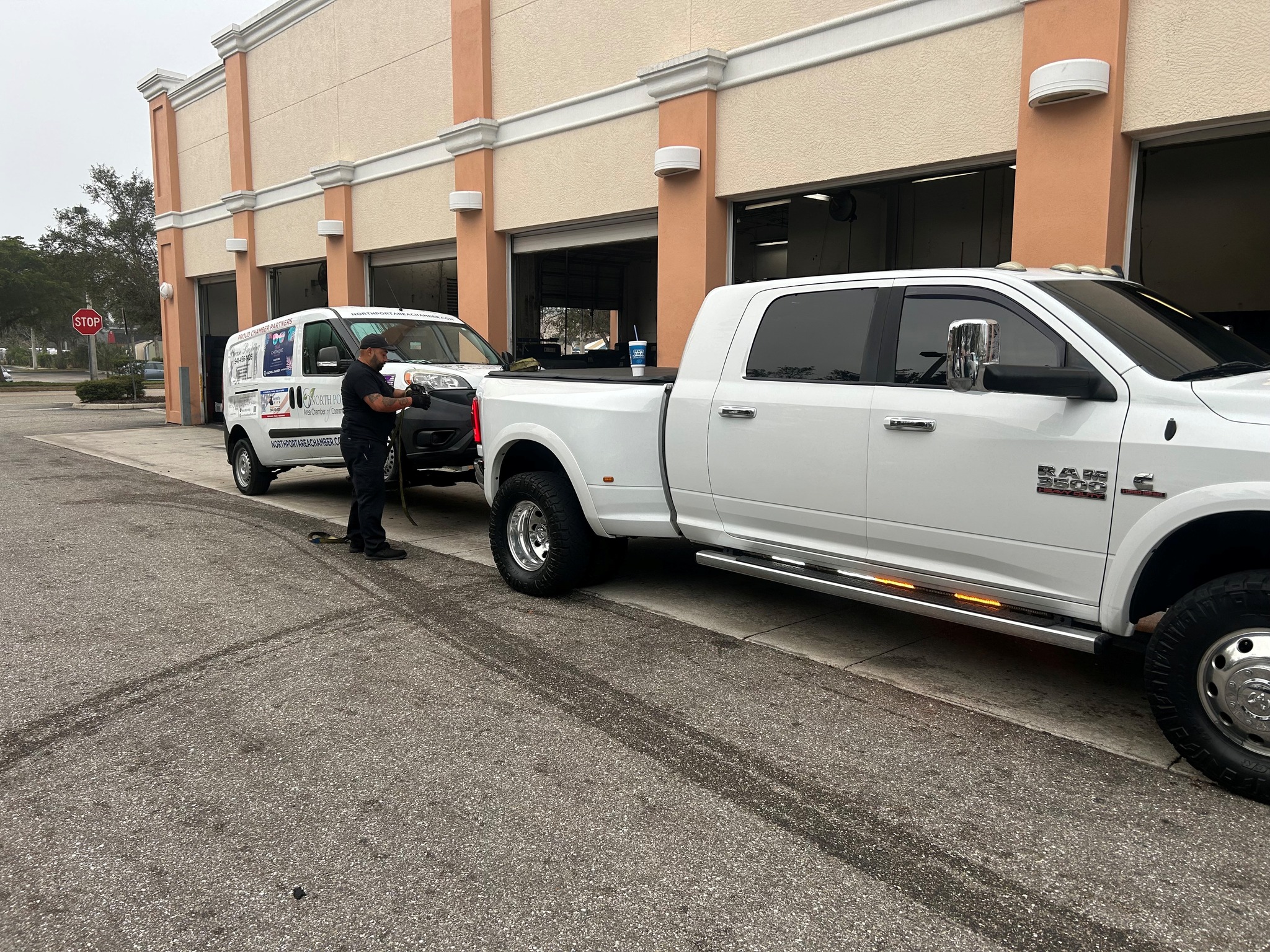 White Ram truck towing a commercial van