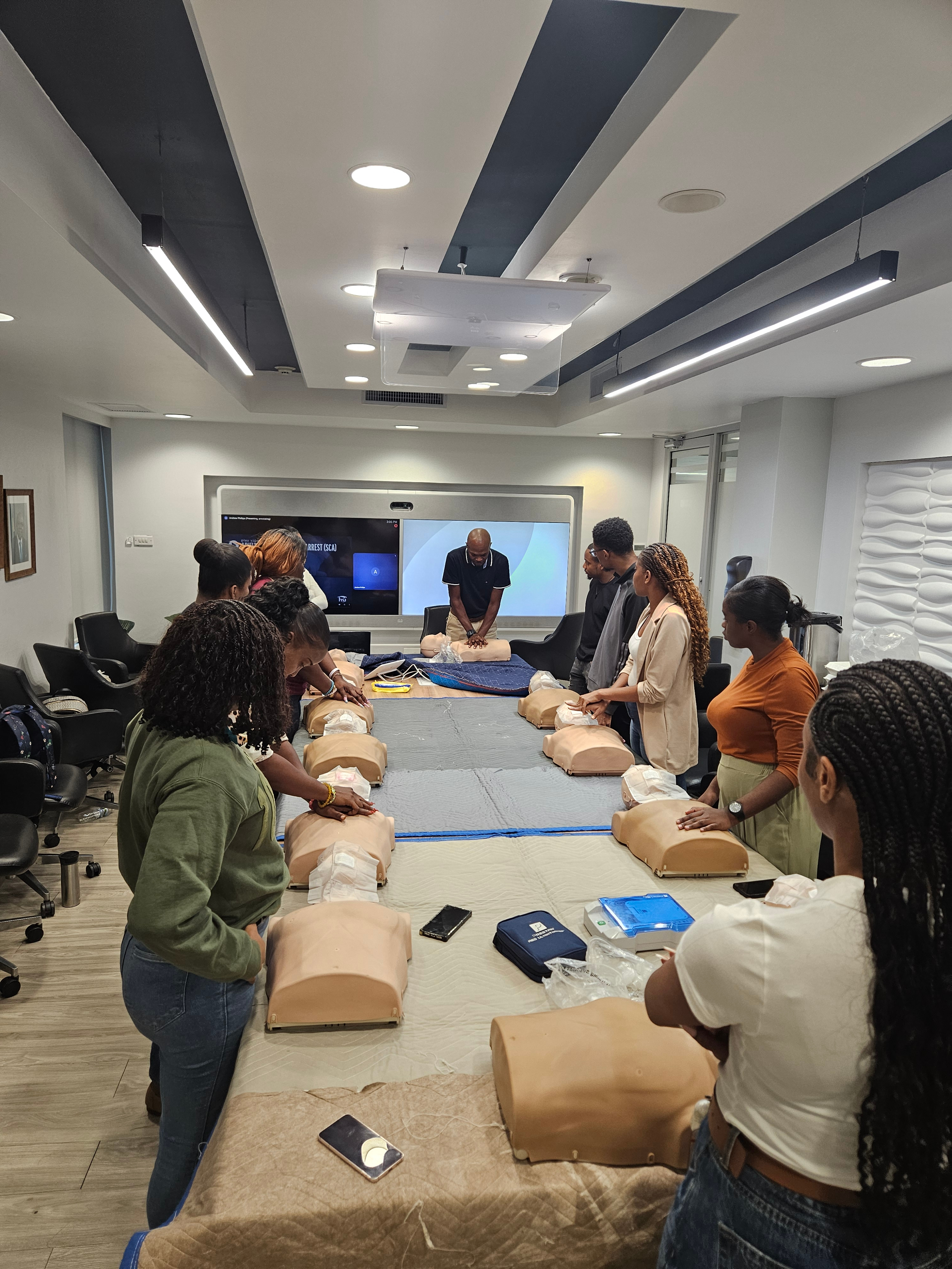 First Response CPR training class in Kingston, Jamaica with students practicing on manikins