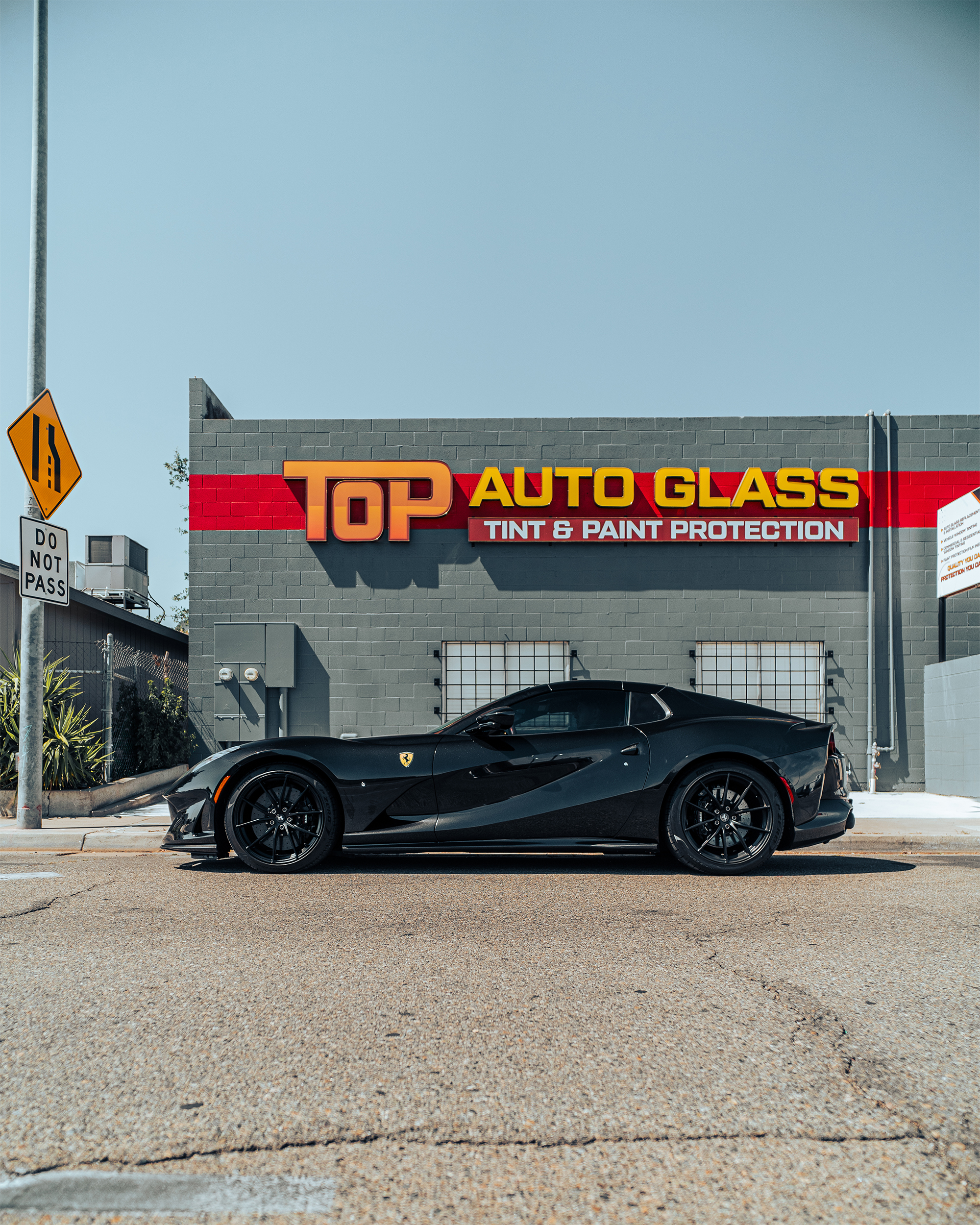 Top Auto Glass storefront with Ferrari