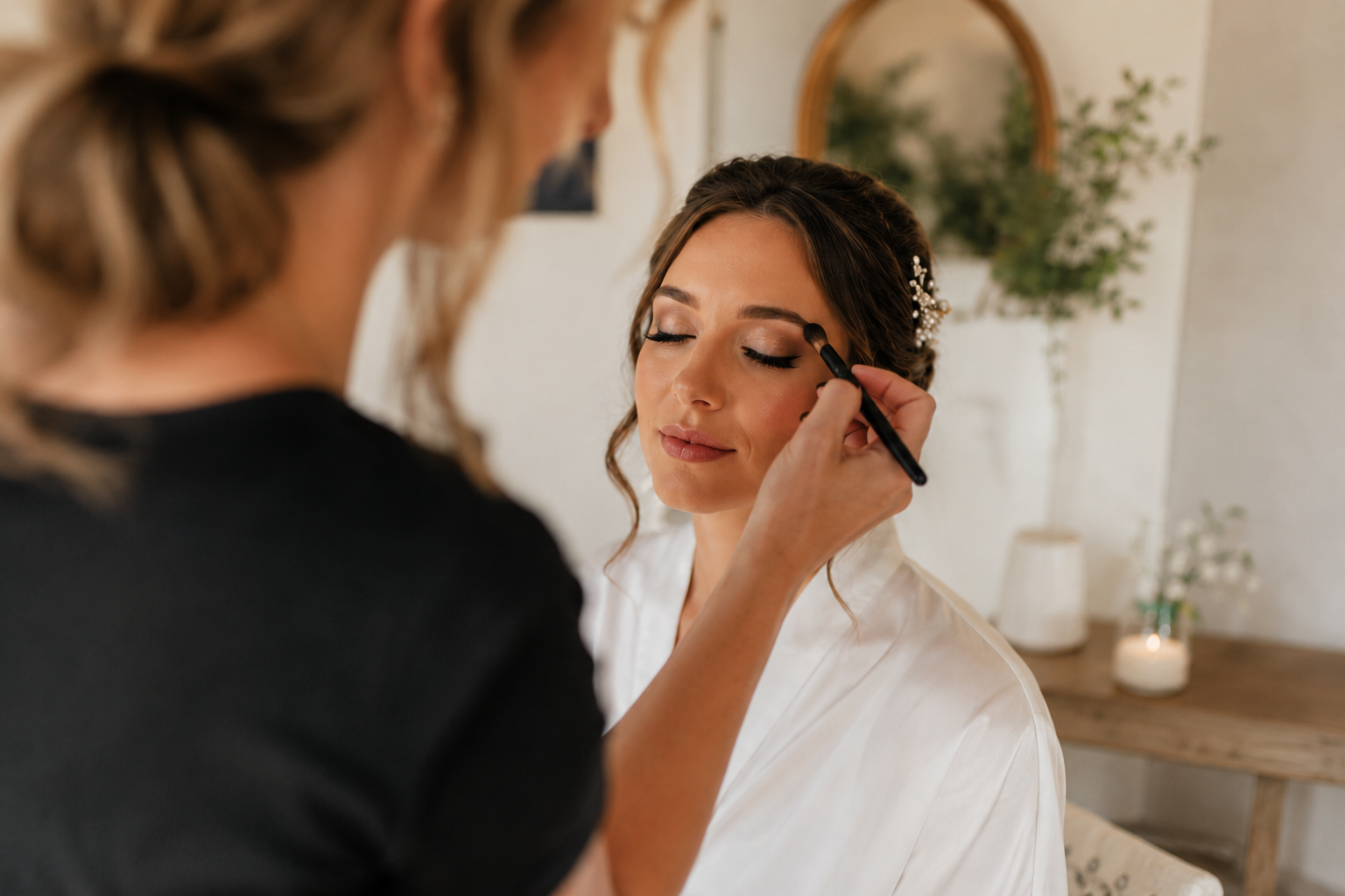 Makeup artist applying makeup to a bride