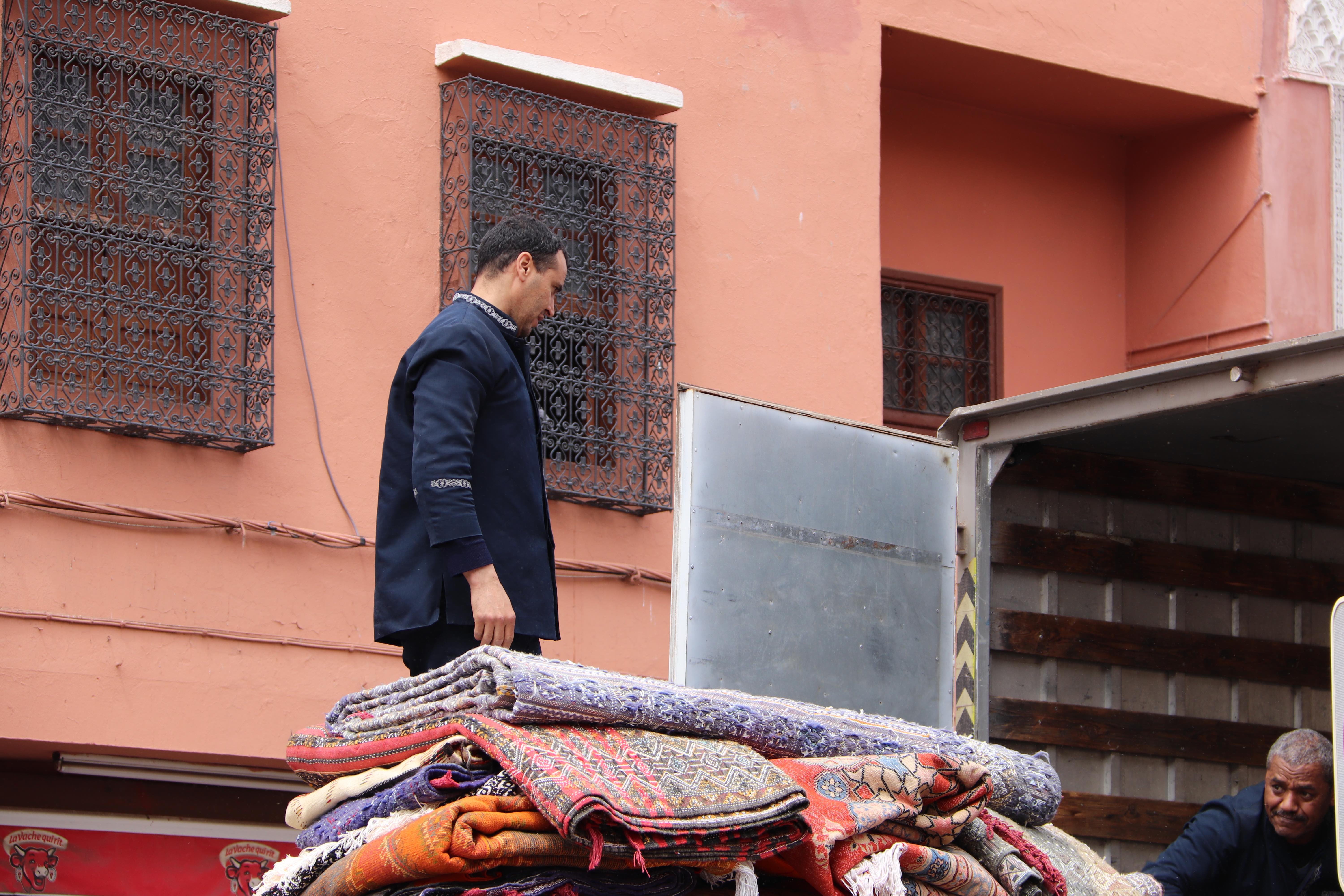 Morocco 2018 - Men with Stack of Moroccan Rugs