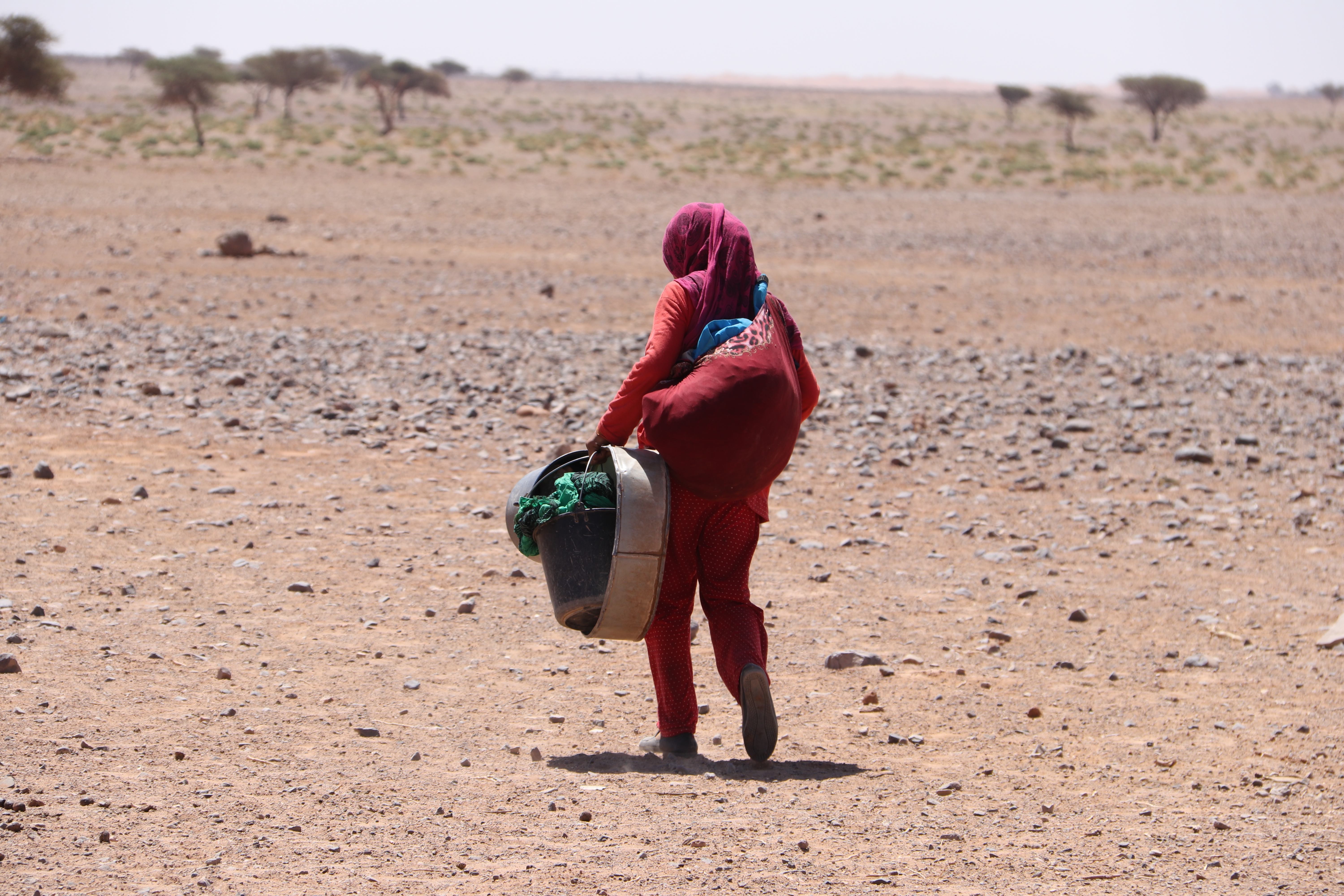 Morocco 2018 - Woman Carrying Water Across the Desert