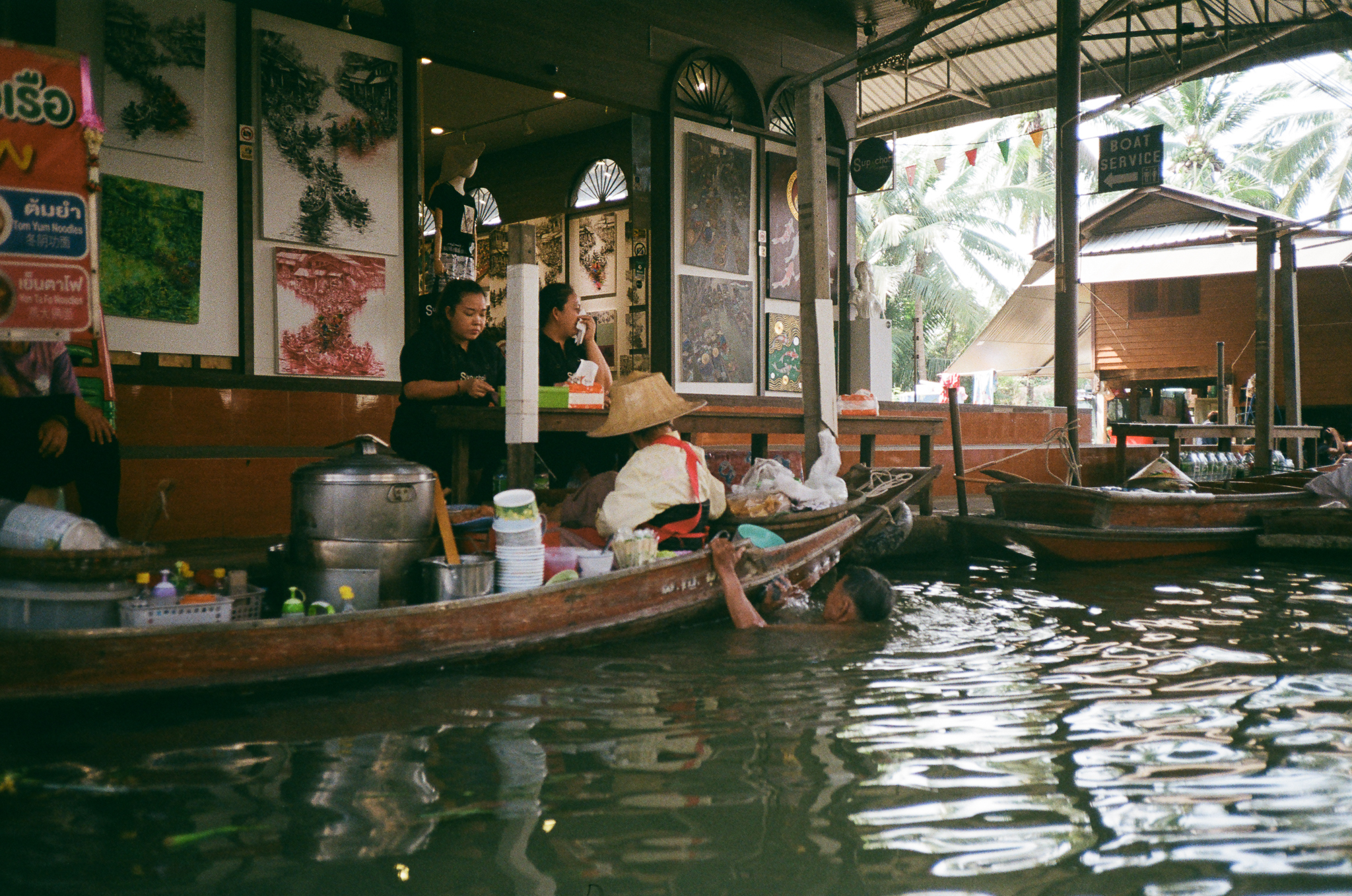 Golden moments in Thailand - Floating Market Vendor with Straw Hat