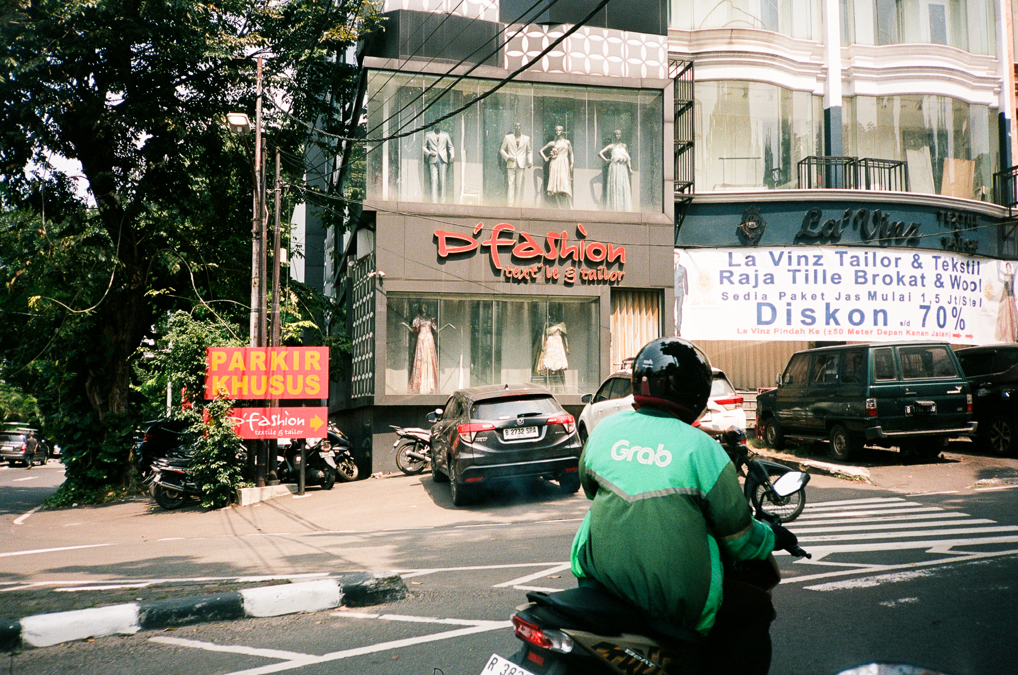 Echoes of Bromo - Grab Driver on Motorbike in Front of Tailor Shop