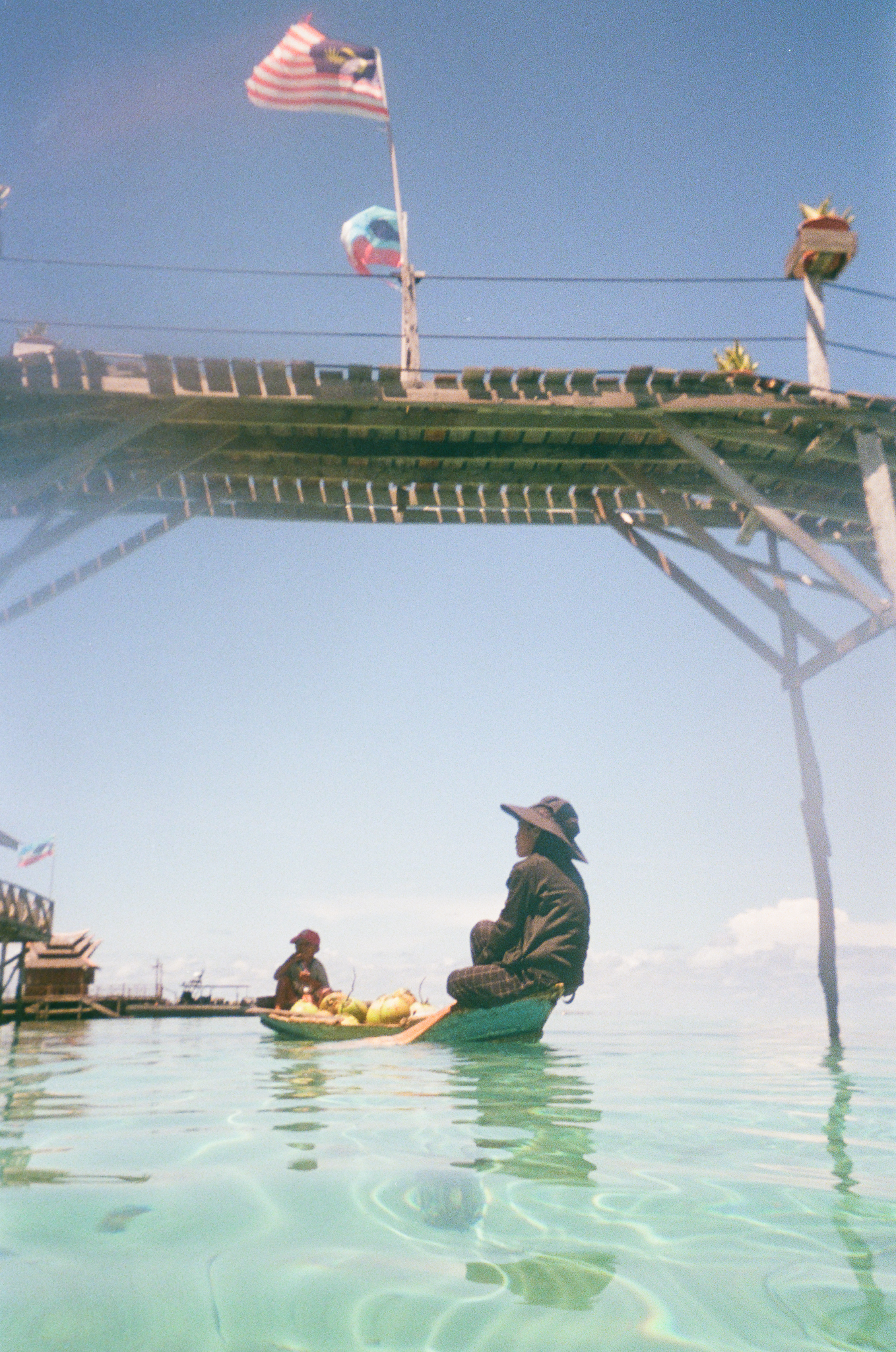 People of the Sea - Woman Poling Under Bridge