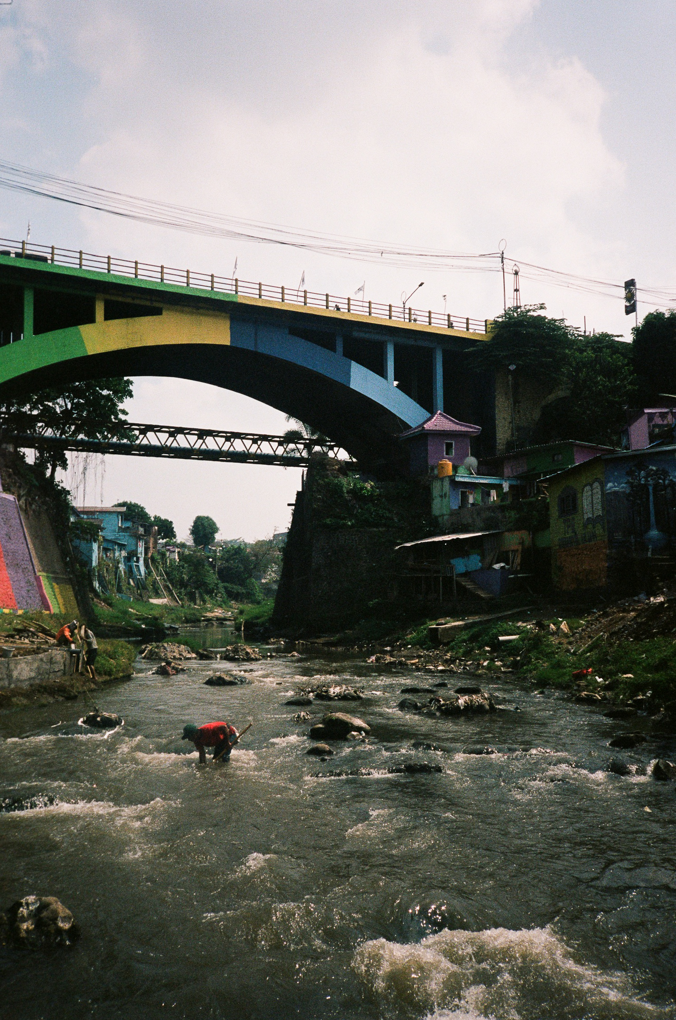 Echoes of Bromo - Rainbow Village with Colorful Bridge over River