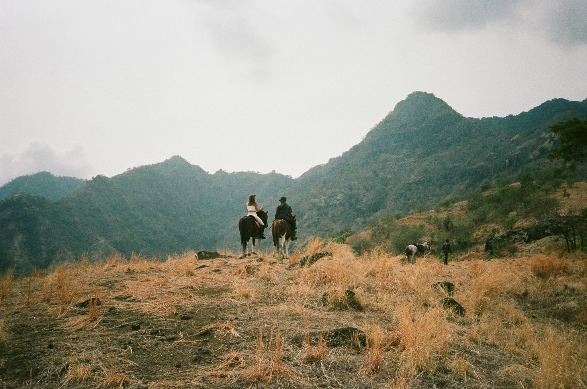 Island of the Gods - Riders on Hill with Mountains
