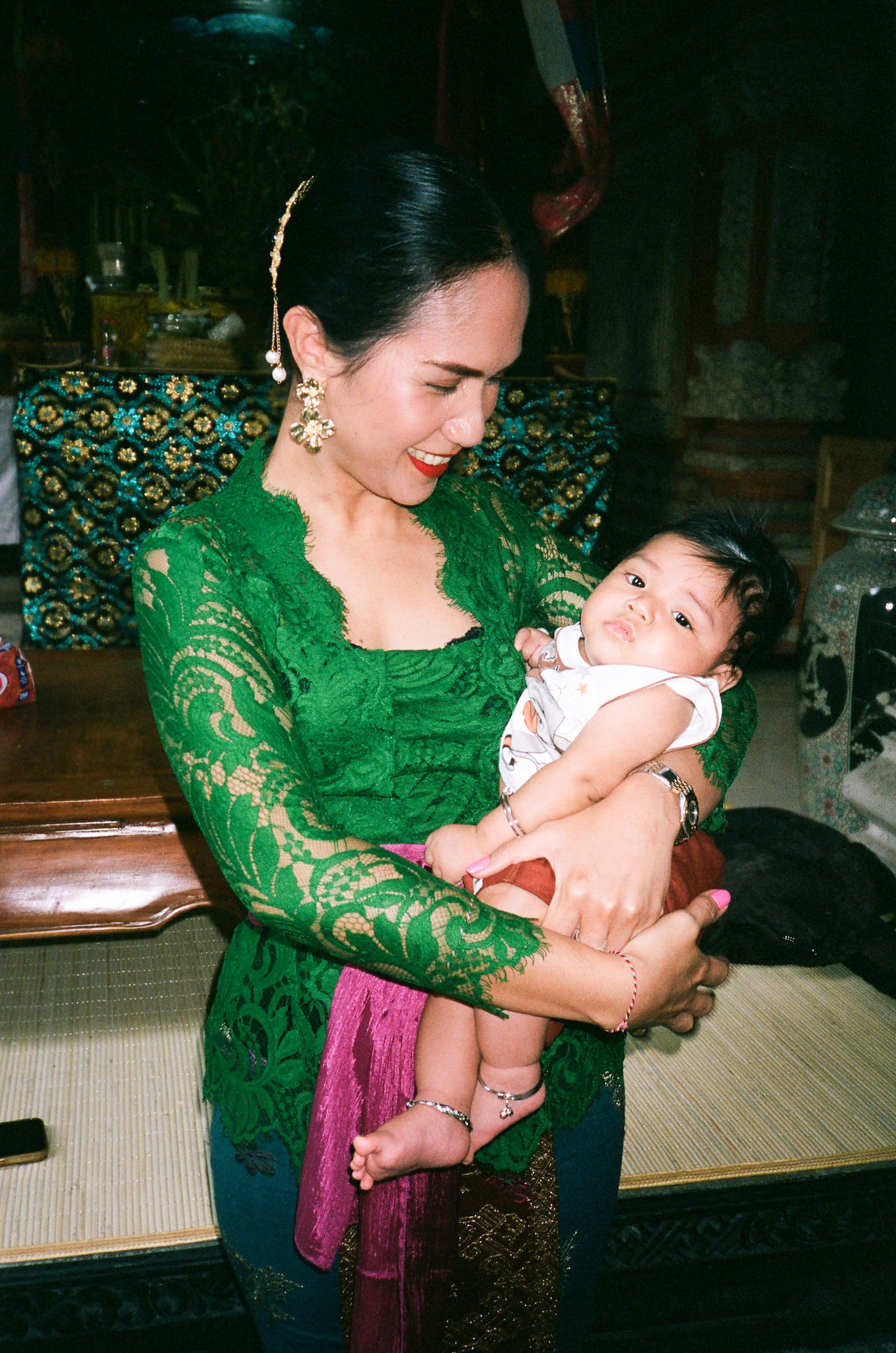 Island of the Gods - Woman in Green Lace Dress Holding Baby