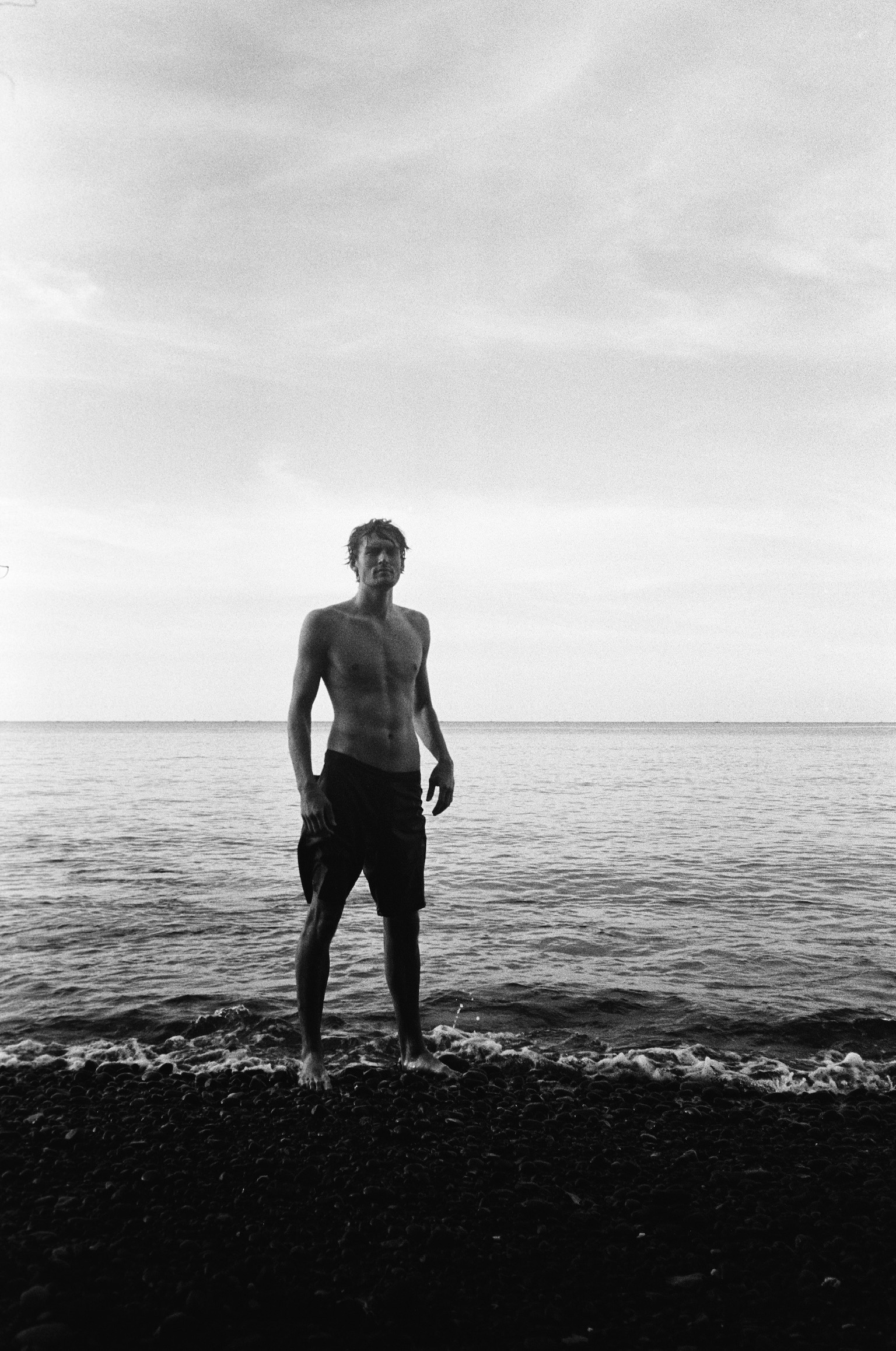 Brother and Sisterhood - Shirtless Man Standing in Ocean B&W