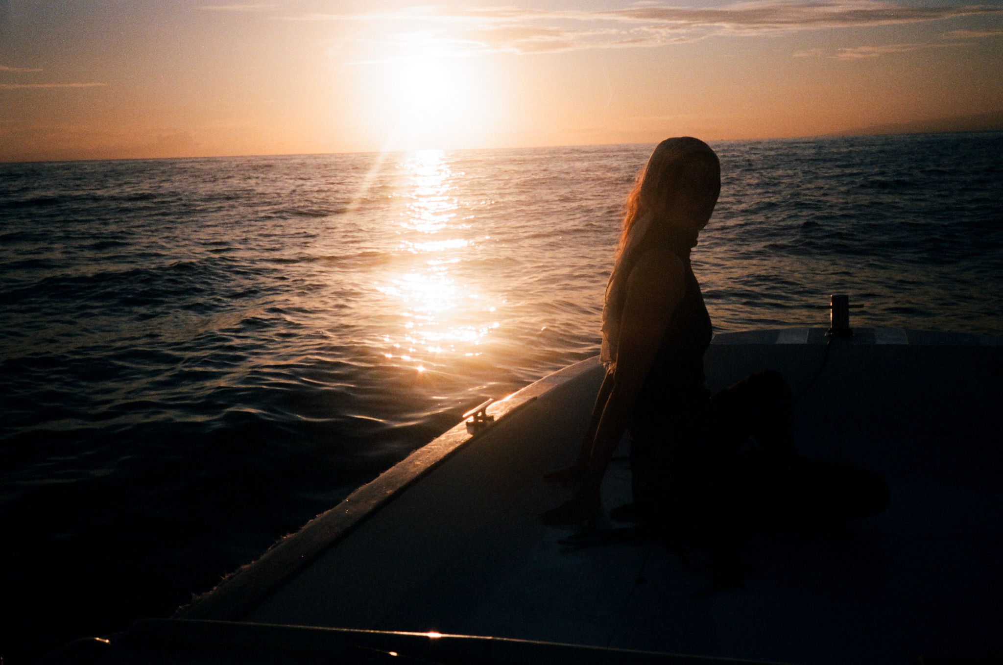 Island of the Gods - Woman Silhouette on Boat at Sunset