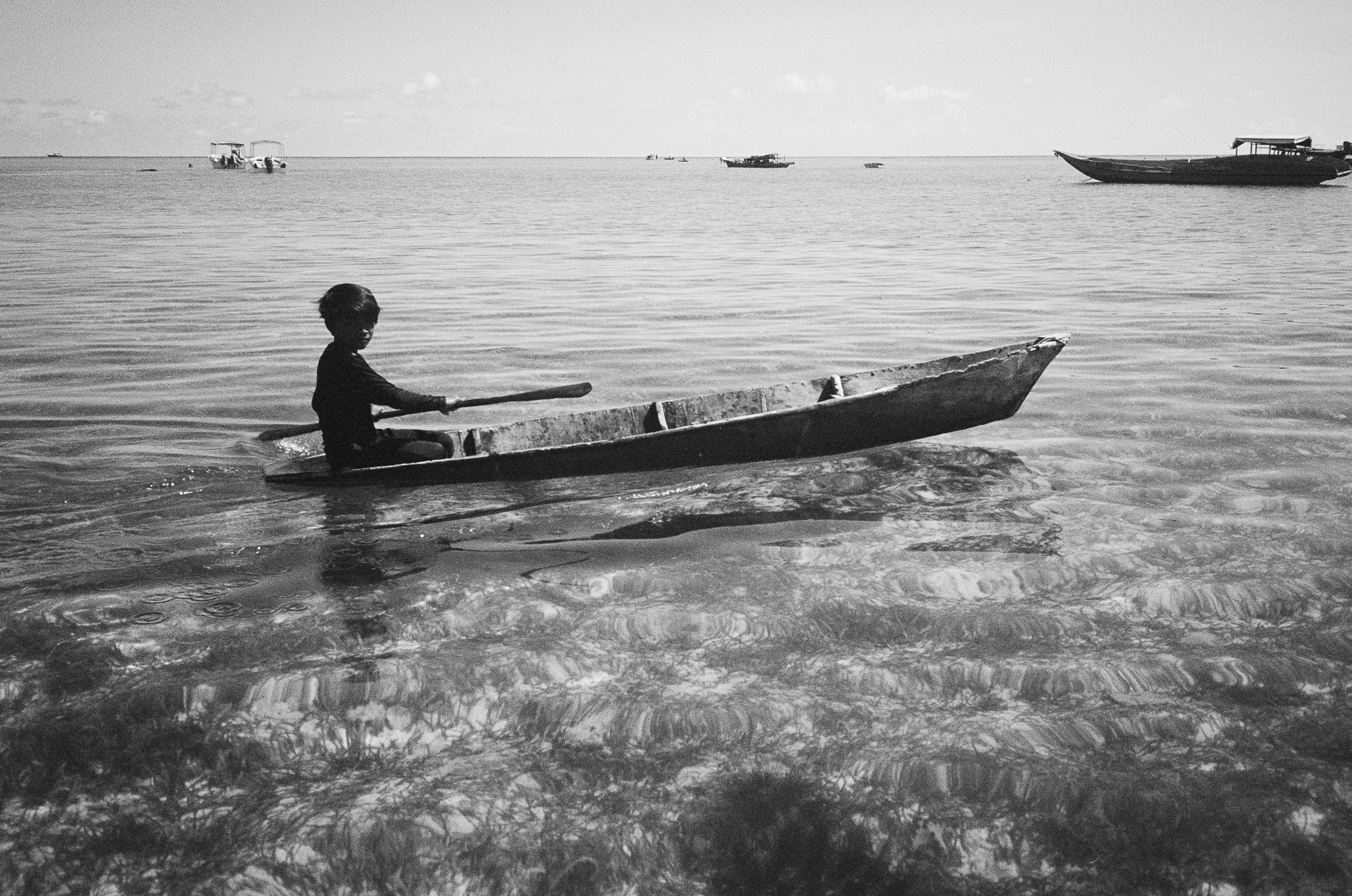 People of the Sea - Boy Poling Boat B&W