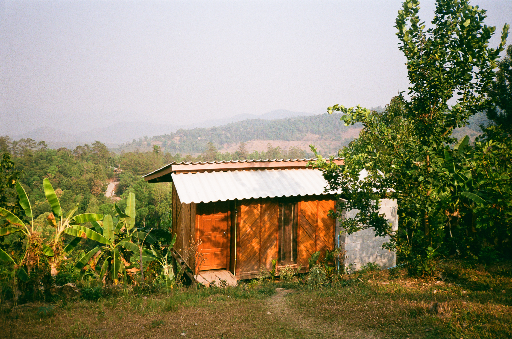 Golden moments in Thailand - Wooden House with Corrugated Roof and Mountains