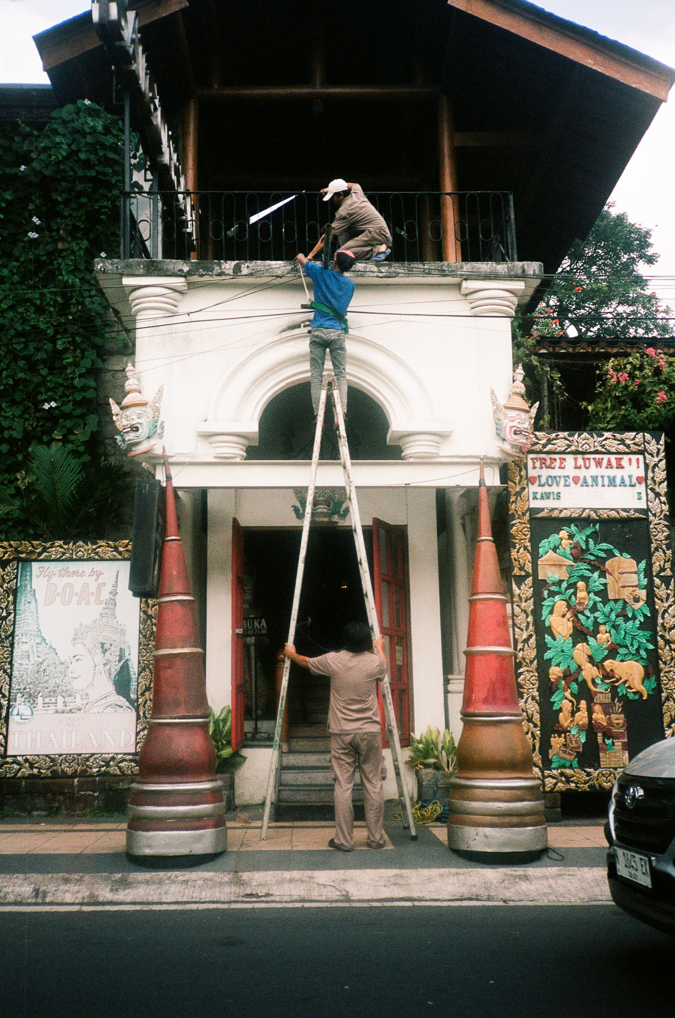 Echoes of Bromo - Temple Entrance with Workers on Ladder