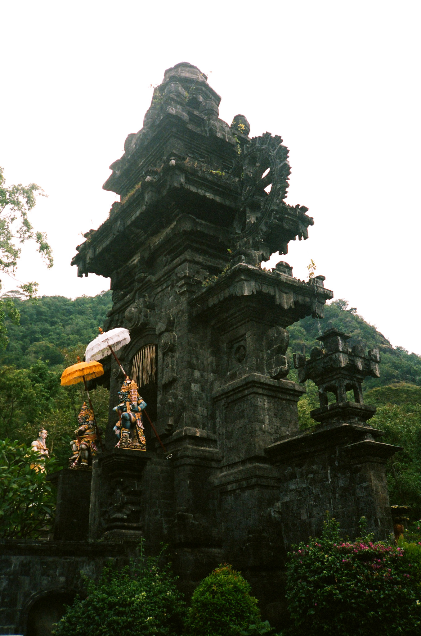 Balinese Ceremony - Temple Gate with Guardian Statues and Umbrellas