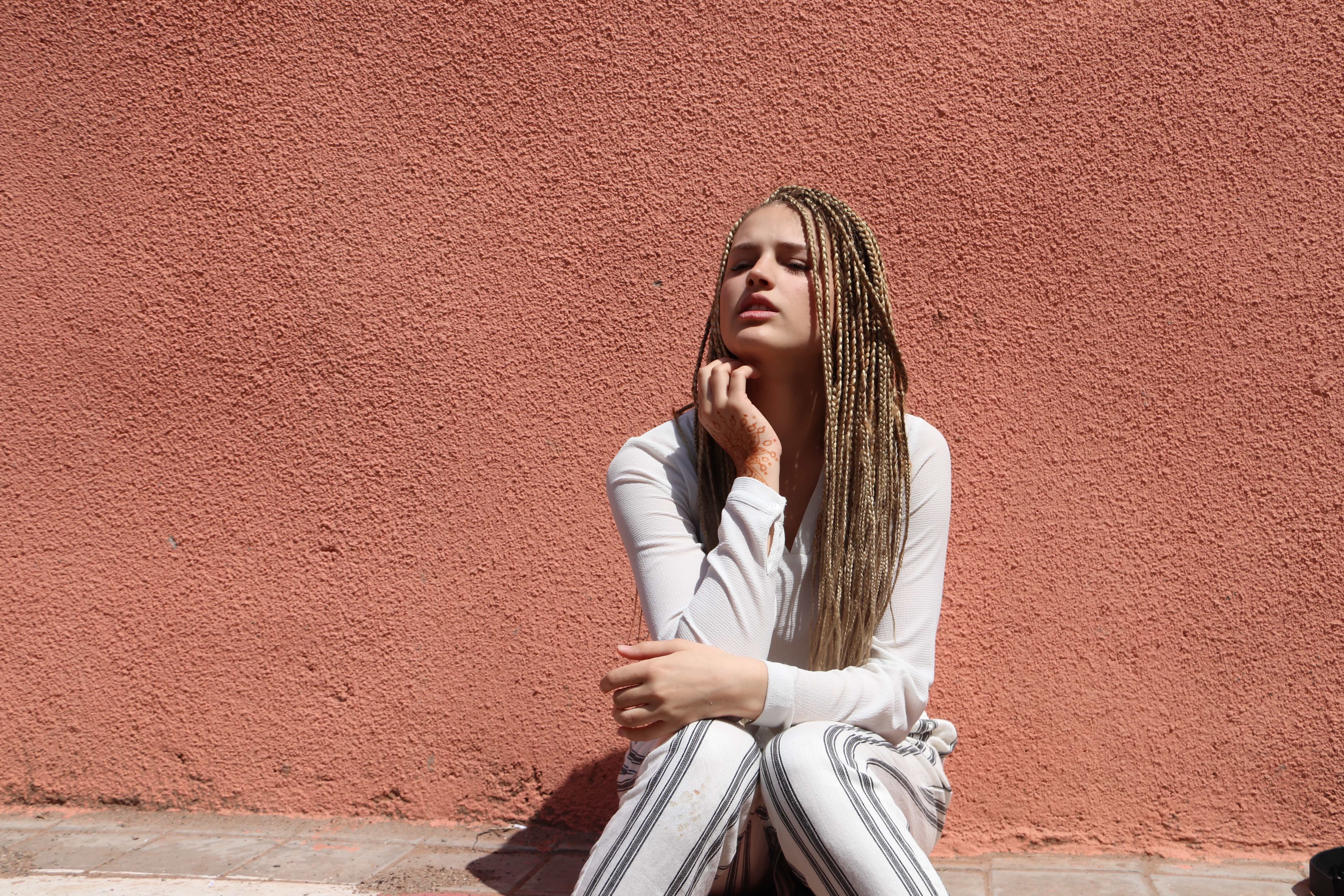 Morocco 2018 - Portrait Girl with Braids Against Terracotta Wall