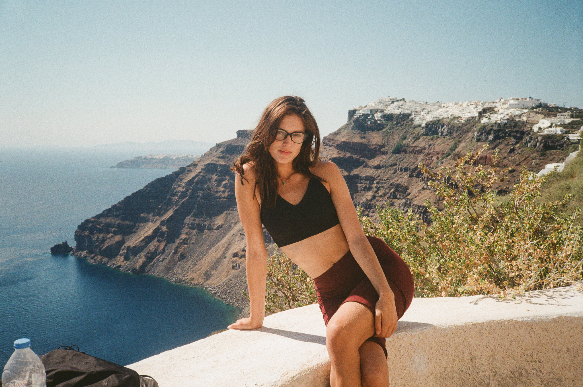 Stories of Greece - Woman on Cliffside Overlooking Santorini