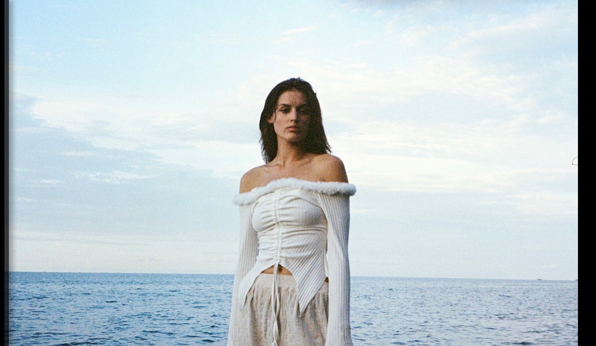 Brother and Sisterhood - Woman in White Off-Shoulder Top at Beach