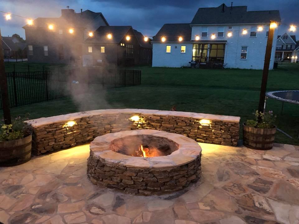 Stone fire pit and patio at dusk