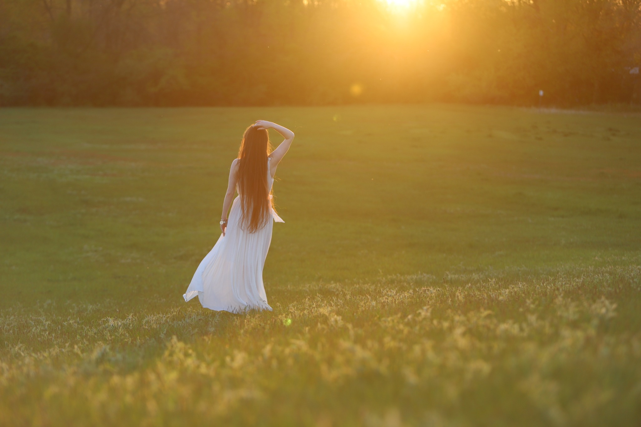 Ashley walking in a sunlit field