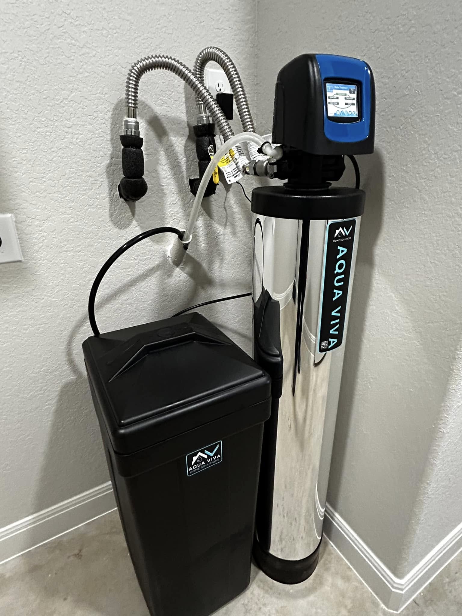 Professional Aqua Viva water softener and brine tank installation in a garage