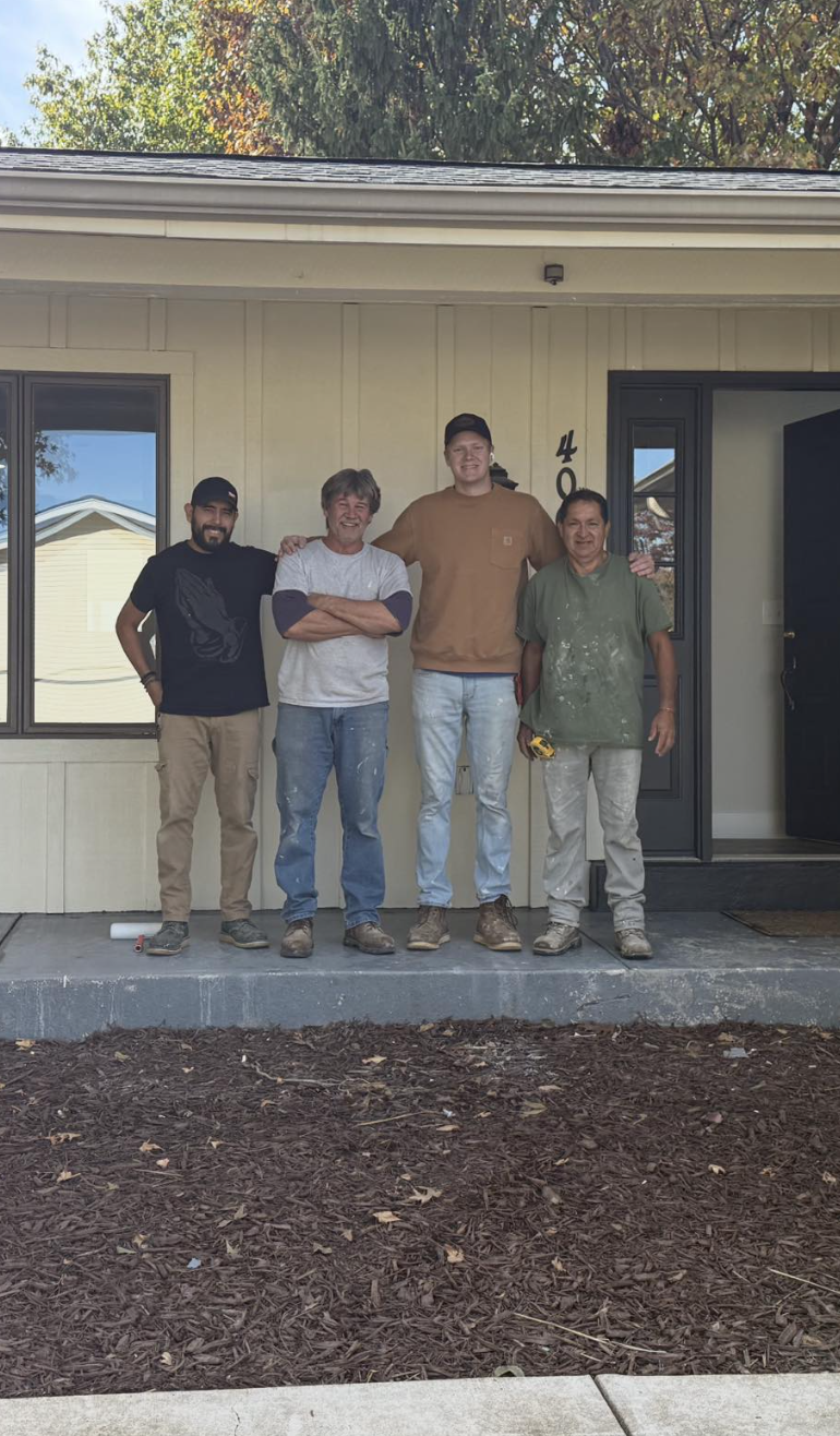 Our team in front of a renovated home