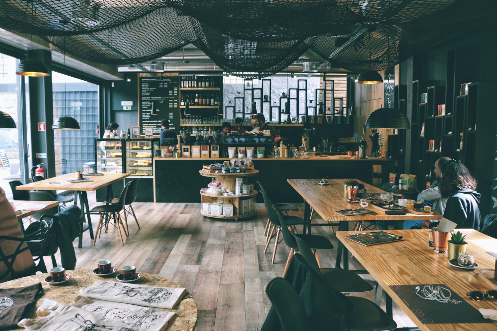 People working in modern cafe on laptops