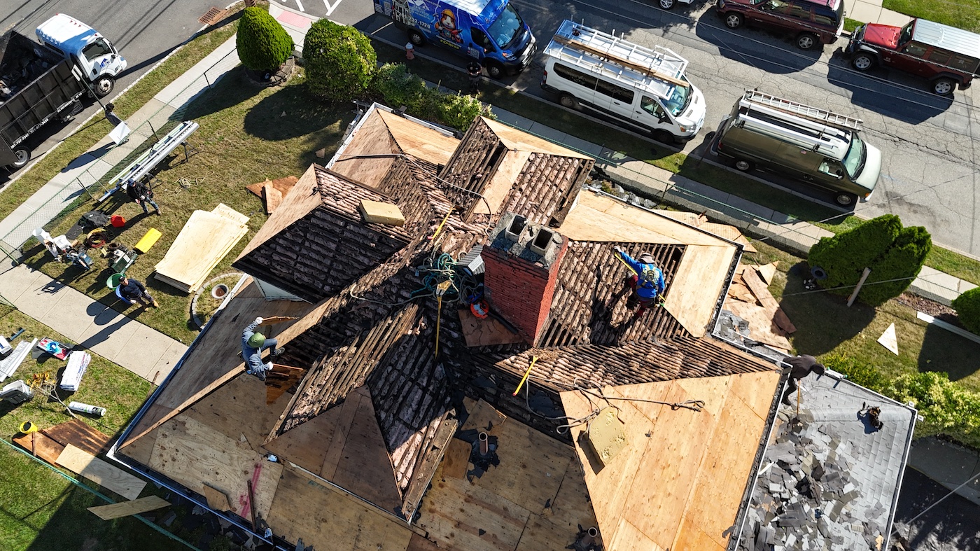 Professional roofing crew mid-installation