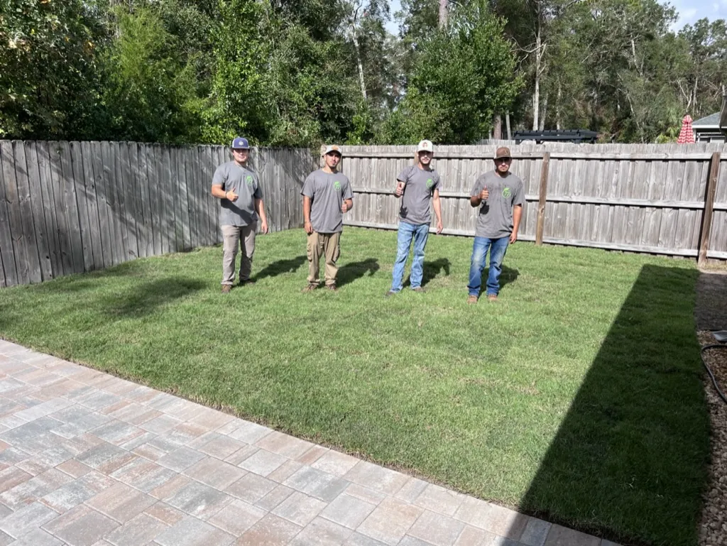 Sod installation team in a residential backyard in Alachua County, FL