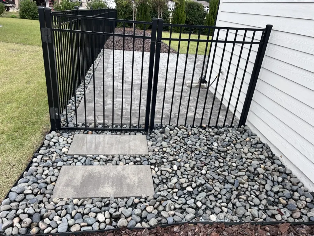 River rock installed around paver walkway