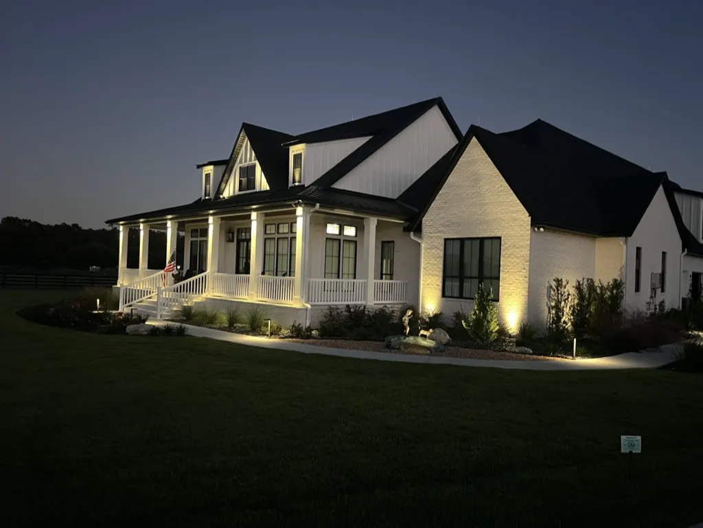 House exterior beautifully illuminated with landscape lighting