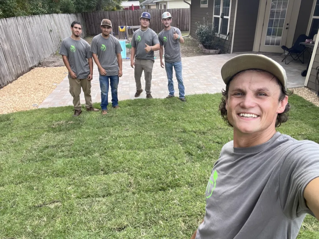 Team standing on freshly installed sod in Alachua County, FL