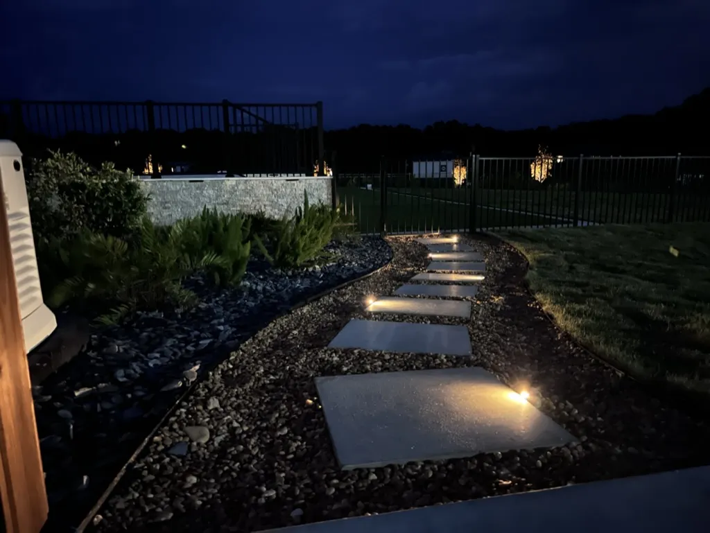 Stepping stone path illuminated by low voltage outdoor lighting