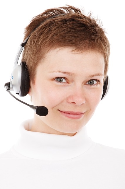 Support representative with headset, smiling, ready to assist with mobility solutions and equipment inquiries.