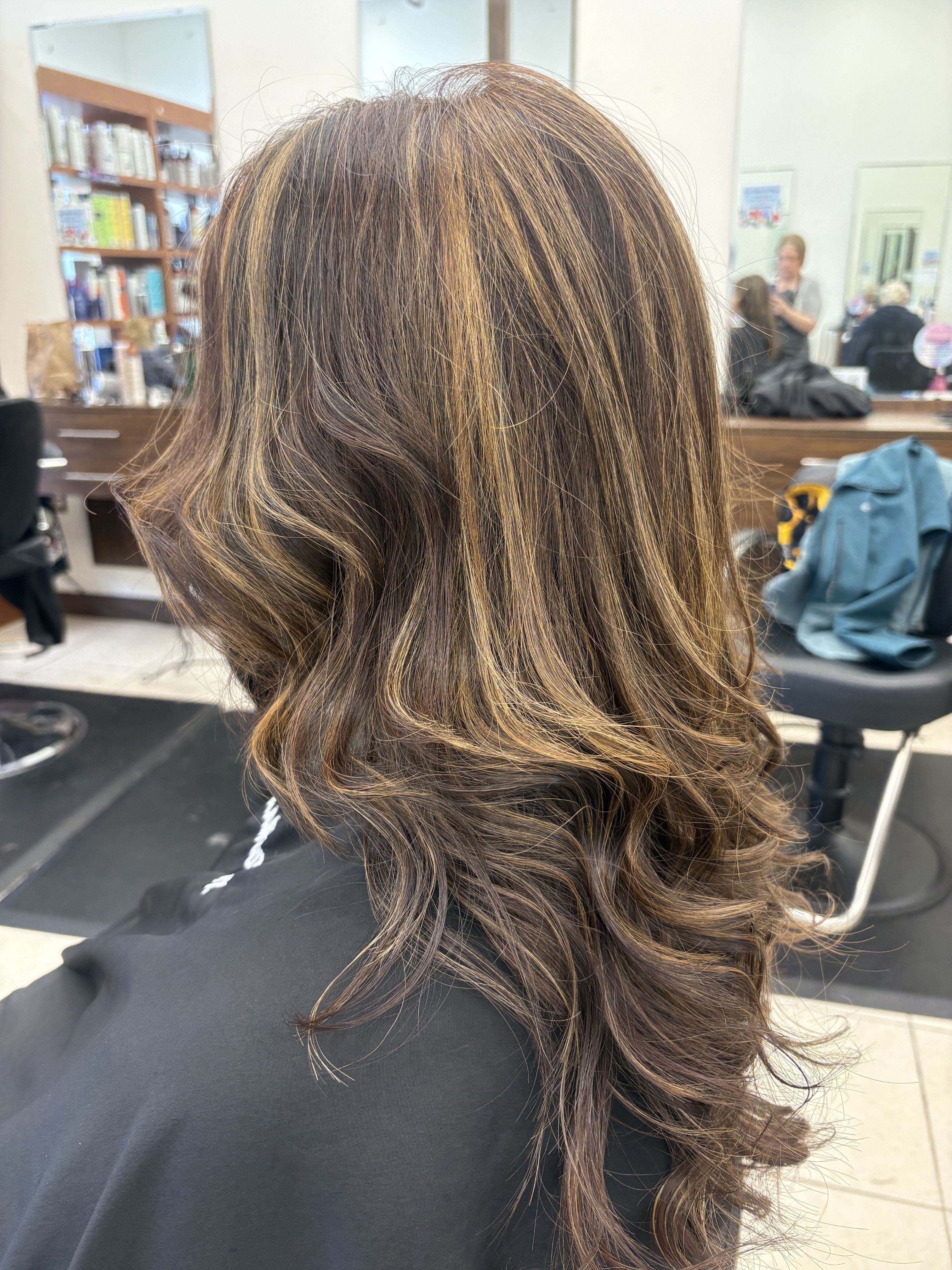 Beautiful dimensional highlights and lowlights on long wavy hair