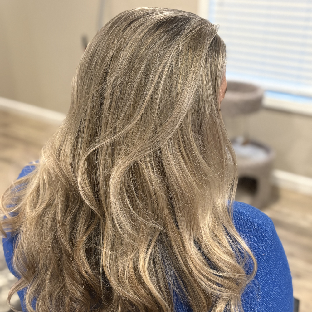 Seamless blonde balayage transformation with healthy styling and dimension in Northside Jacksonville