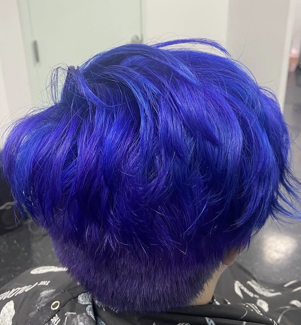 After photo of a corrective vivid blue hair color transformation showing healthy, vibrant results