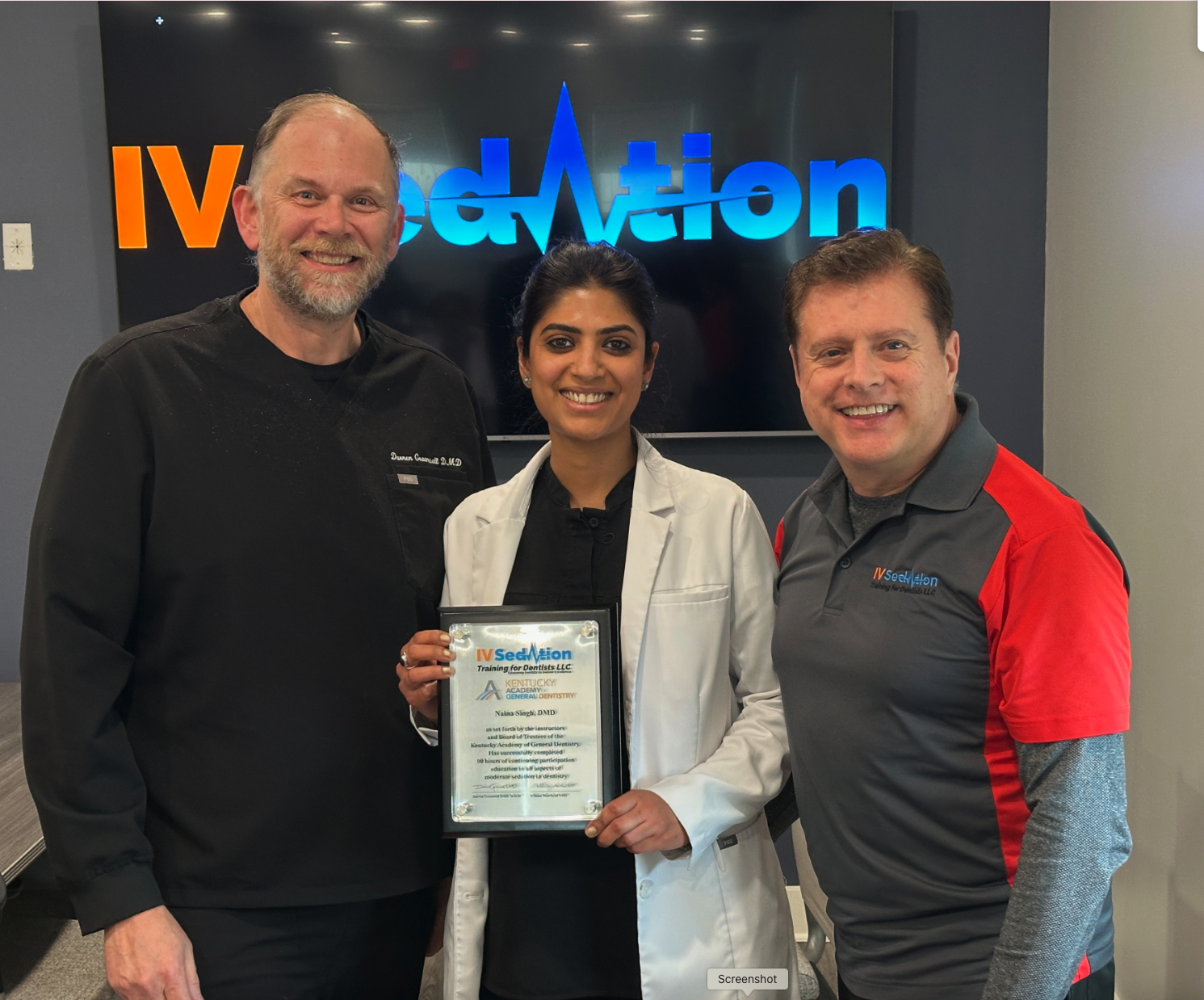 Dentists holding certification plaque