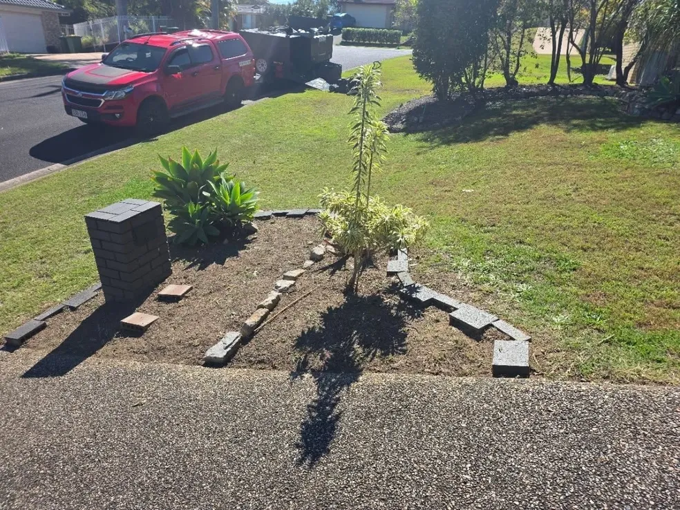Landscaped front garden bed with pruned plants