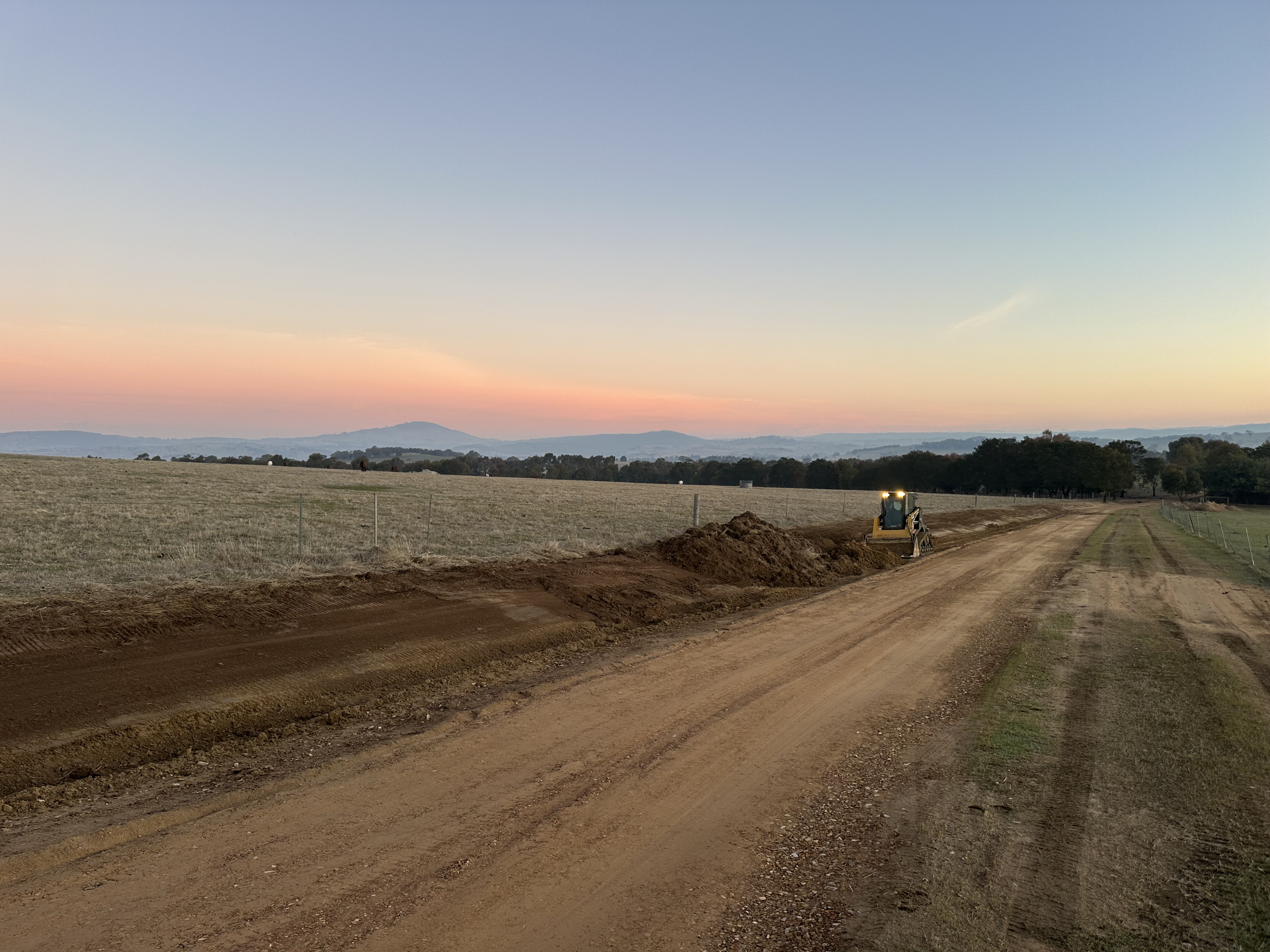 Earthmoving equipment at sunset