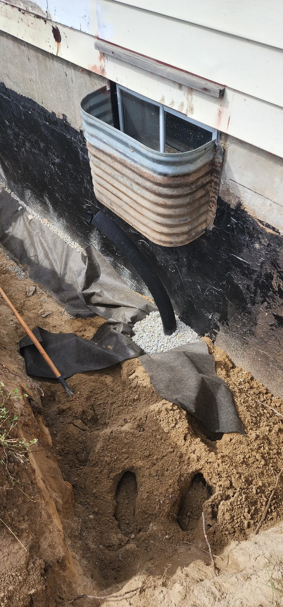 Window well drainage installation