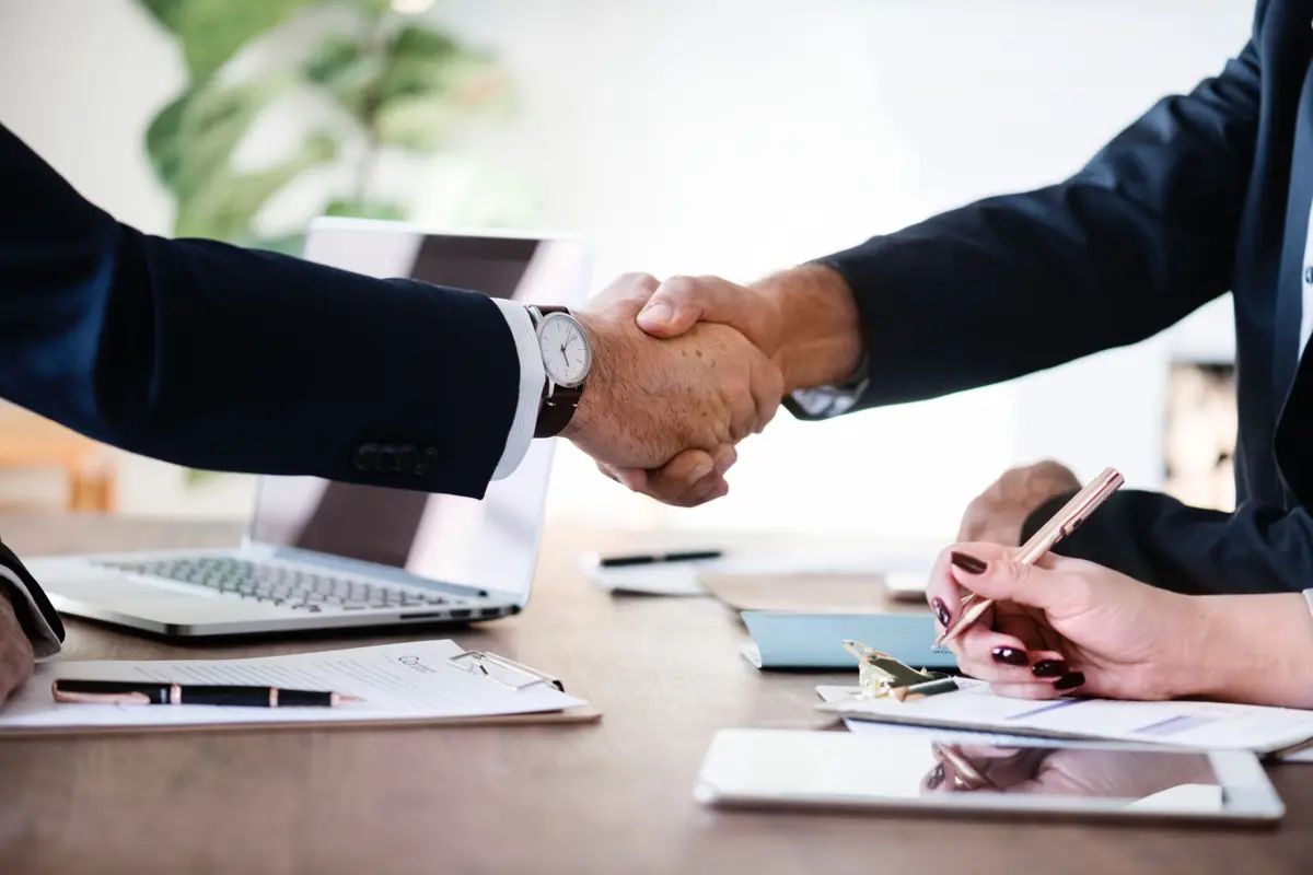 Business partnership handshake and agreement
