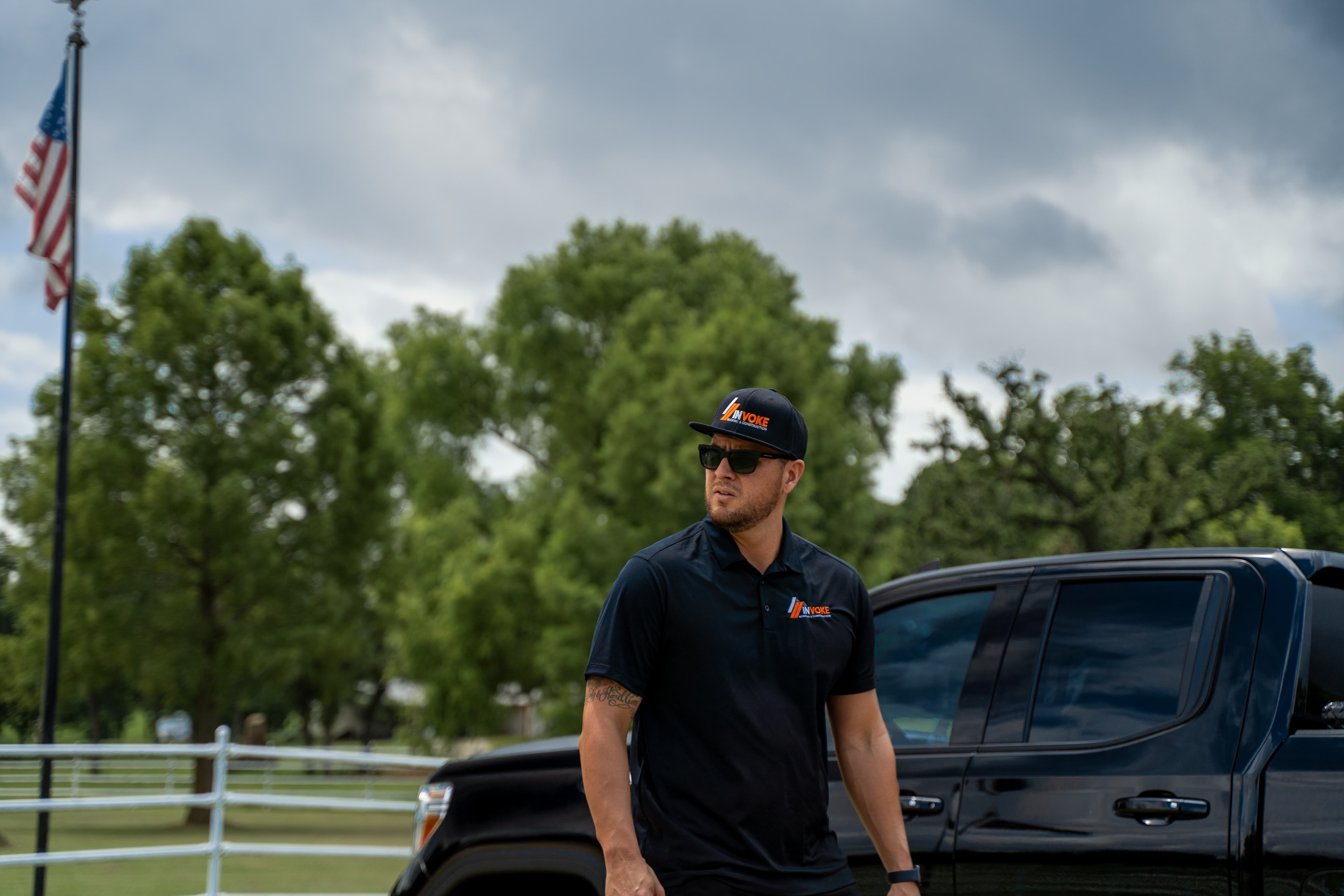 Invoke Roofing team member near truck