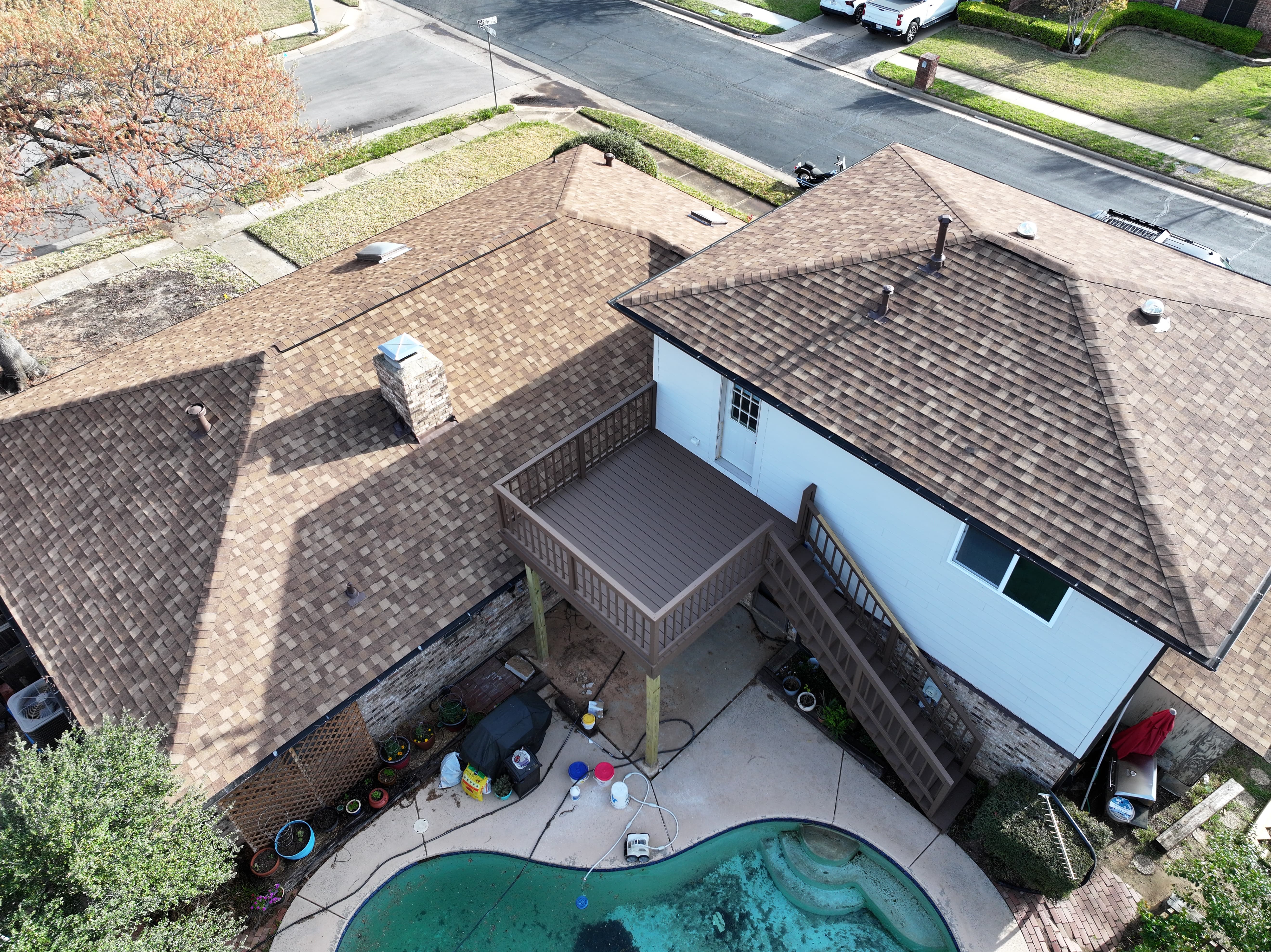 Drone view of residential roof and deck