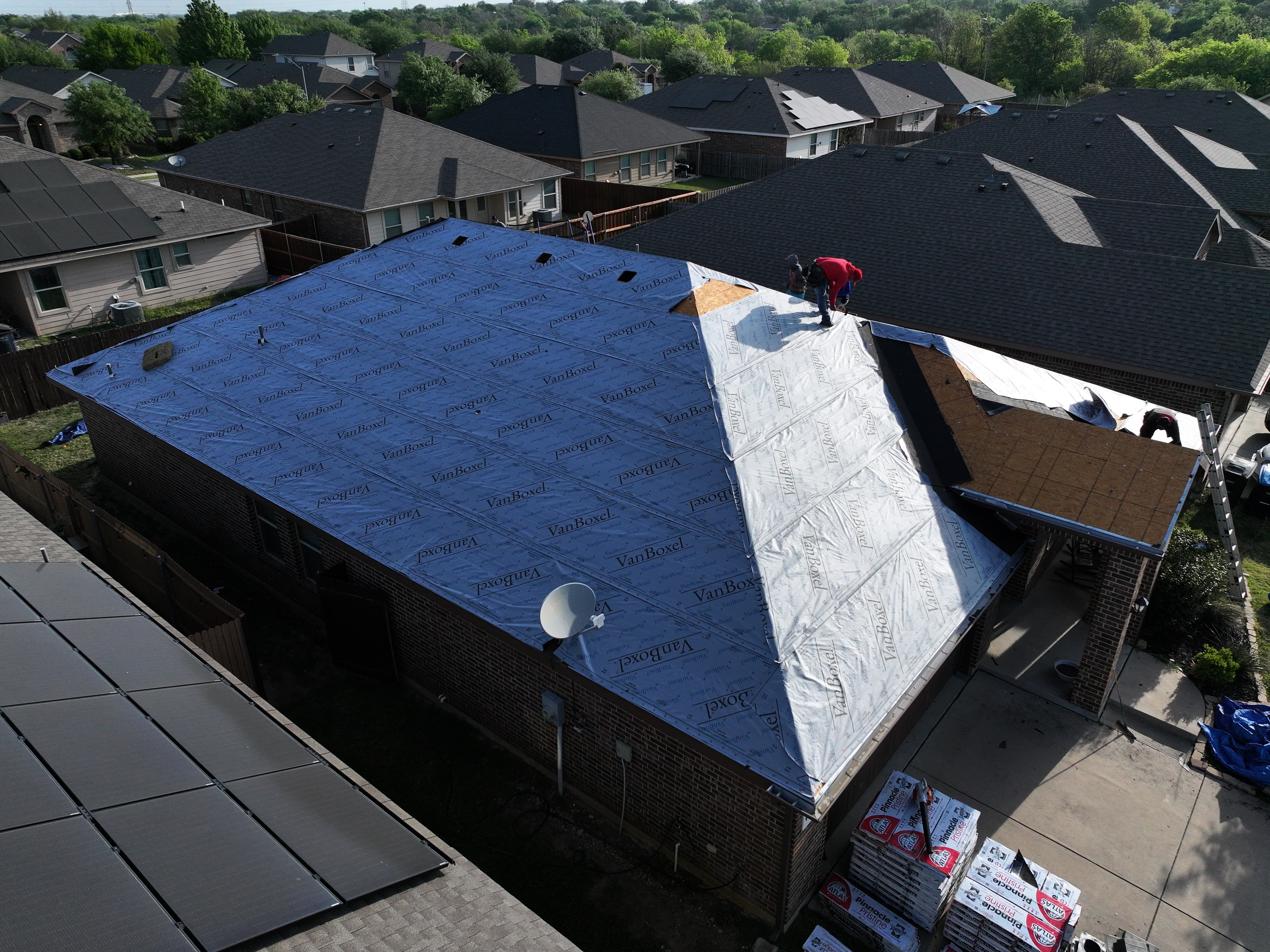 Roofing workers on a residential roof