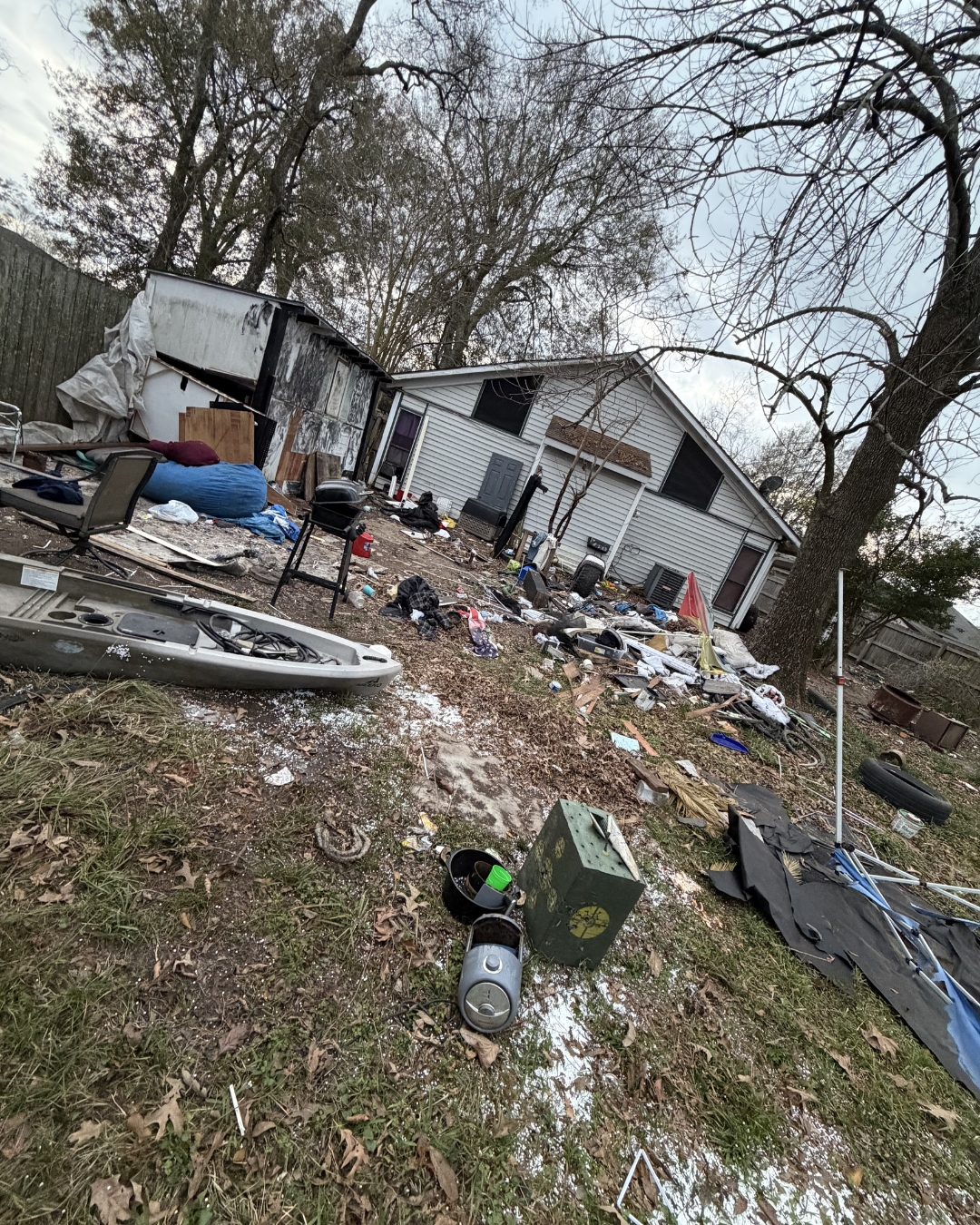 Cluttered yard with junk before removal