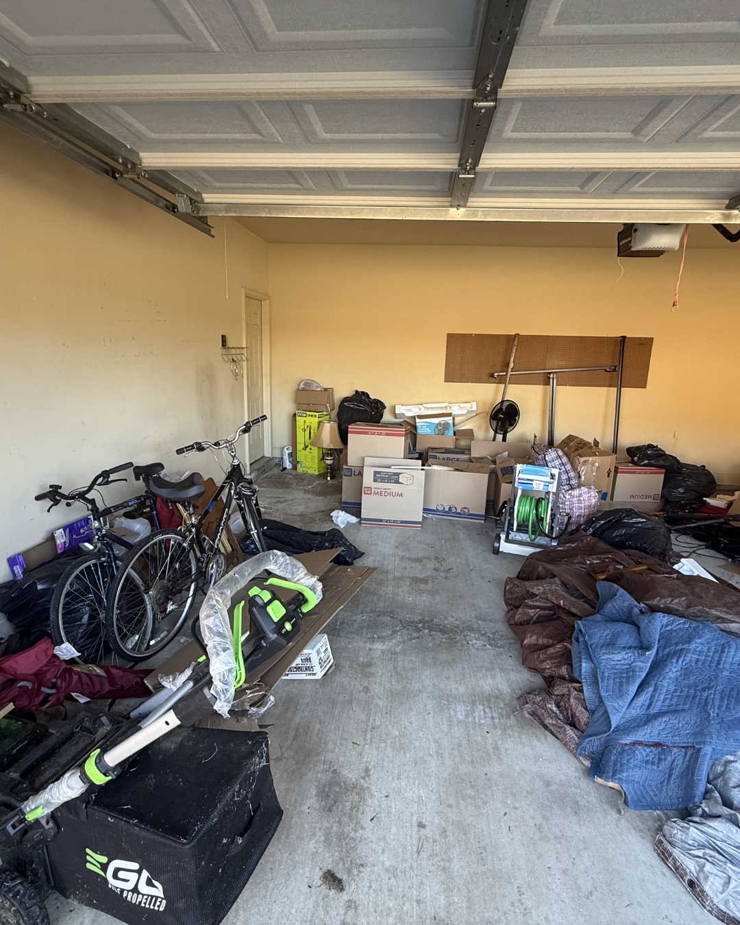Cluttered garage before junk removal