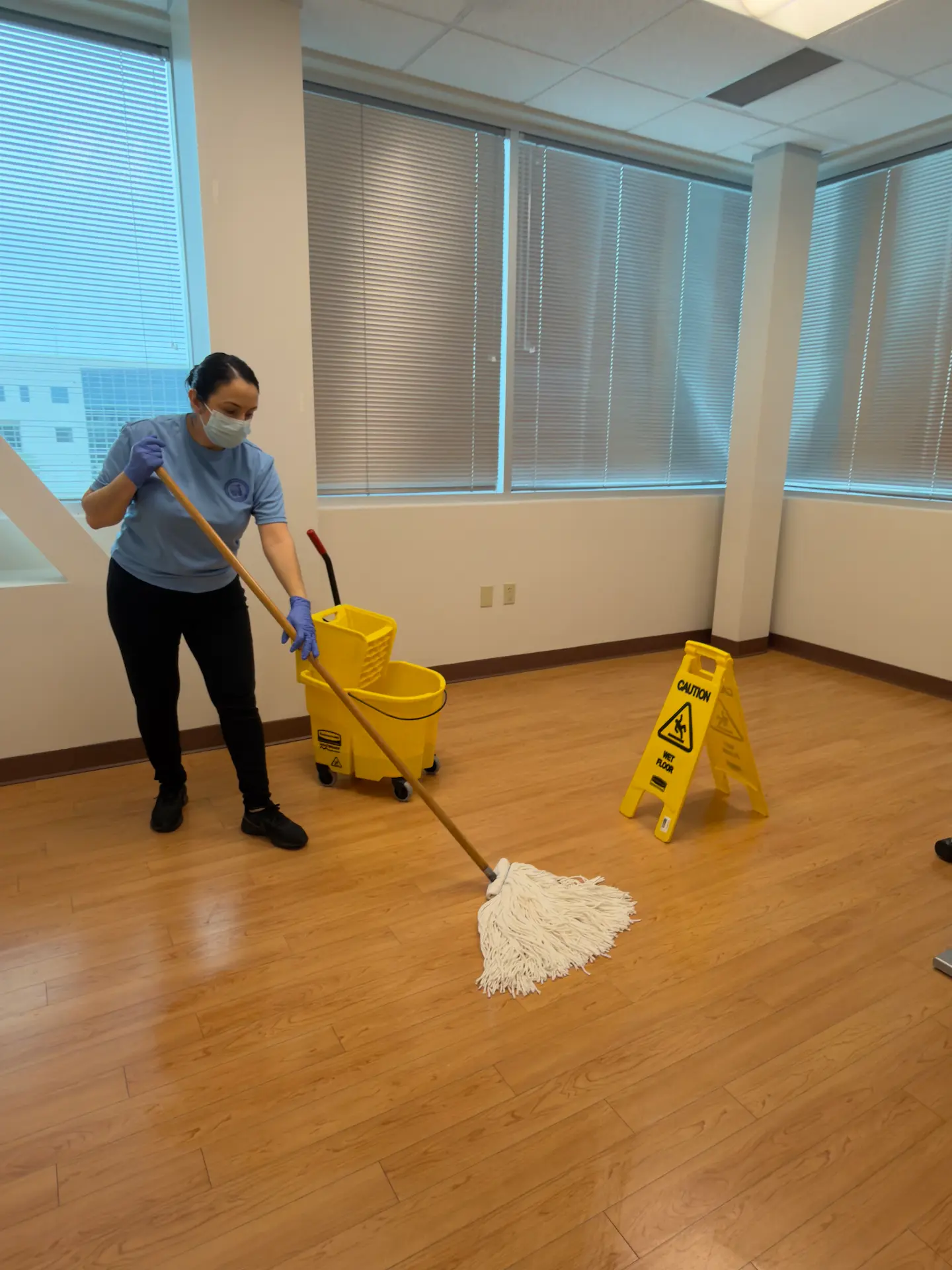 Professional commercial cleaner mopping the floor
