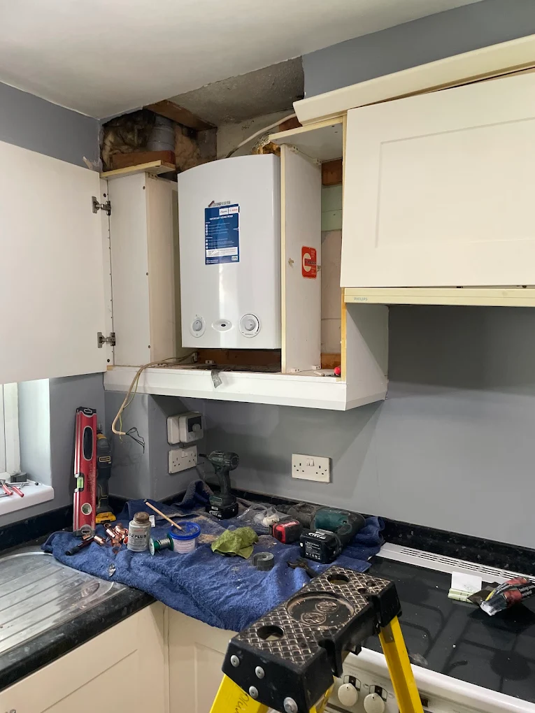Gas Safe registered engineer repairing a boiler in Surrey