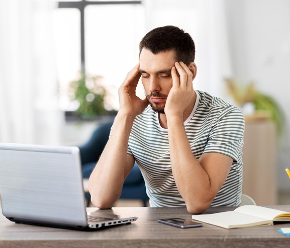Stressed man at laptop